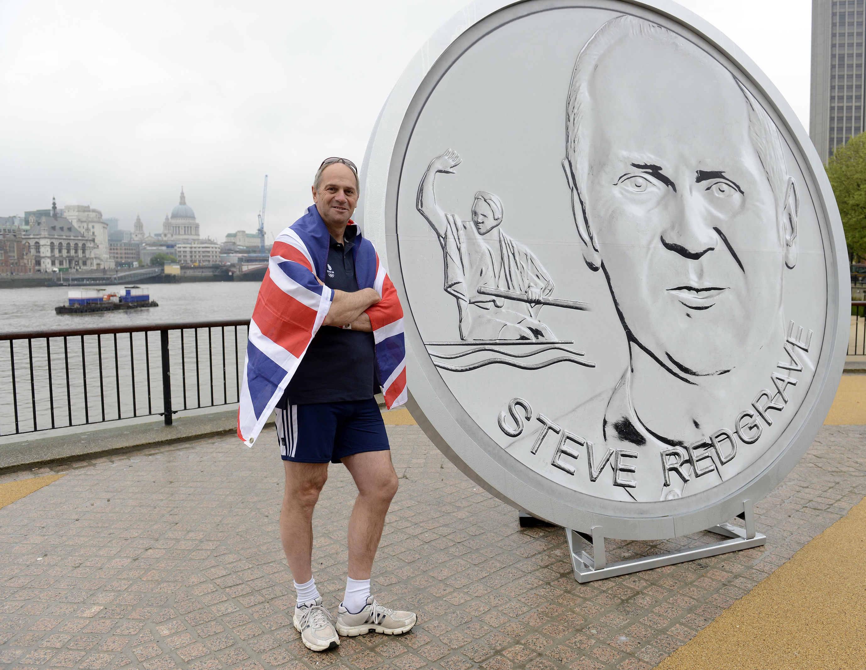 Sir Steve Redgrave stands in front of a giant medallion, featuring his face and a Olympic celebratory pose, on the Southbank, London, during the launch of Our Greatest Team Legends Collection in 2012 (Rebecca Naden/PA)