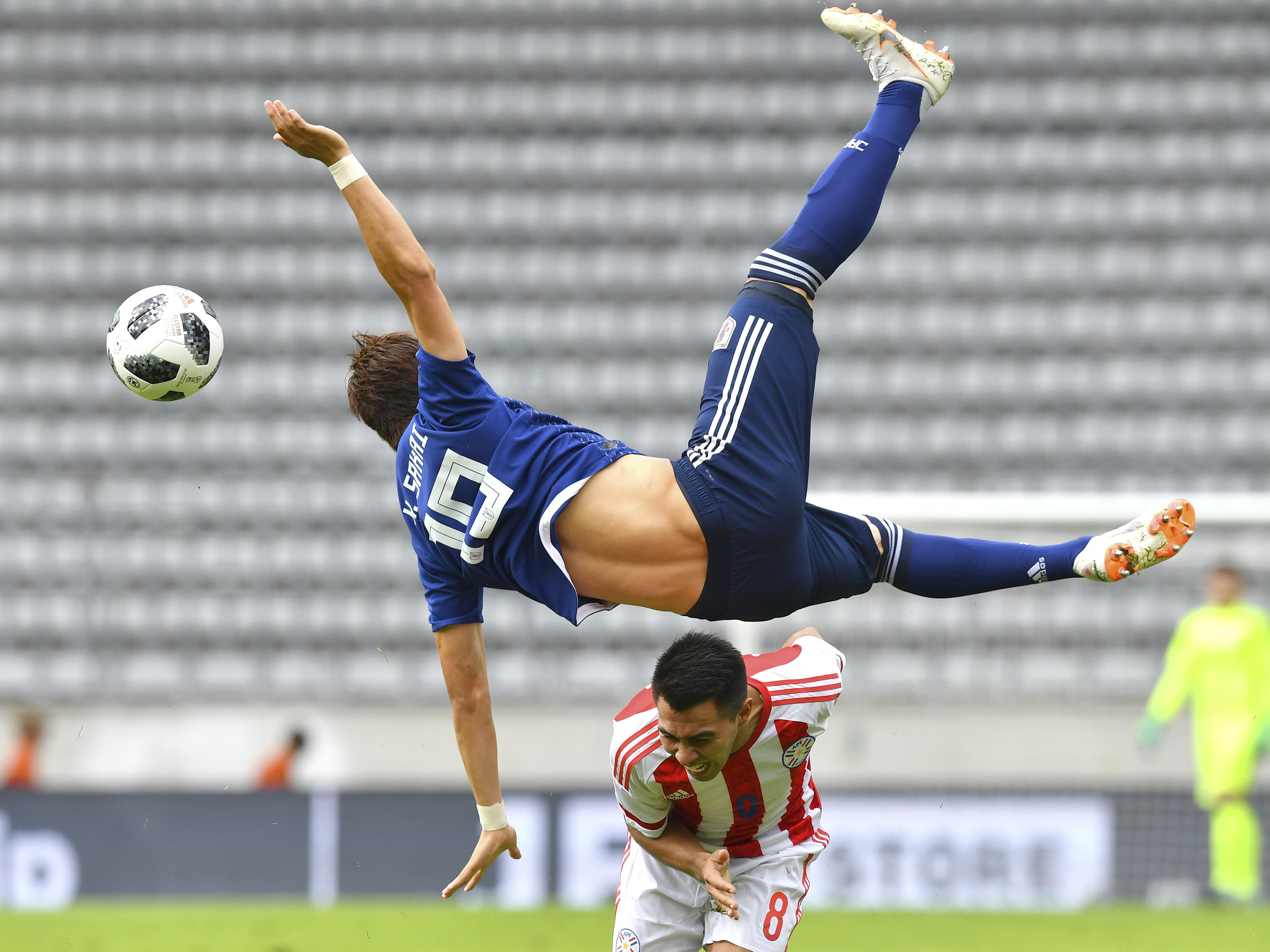 Japan's Shinji Kagawa leaps for the ball against Paraguay