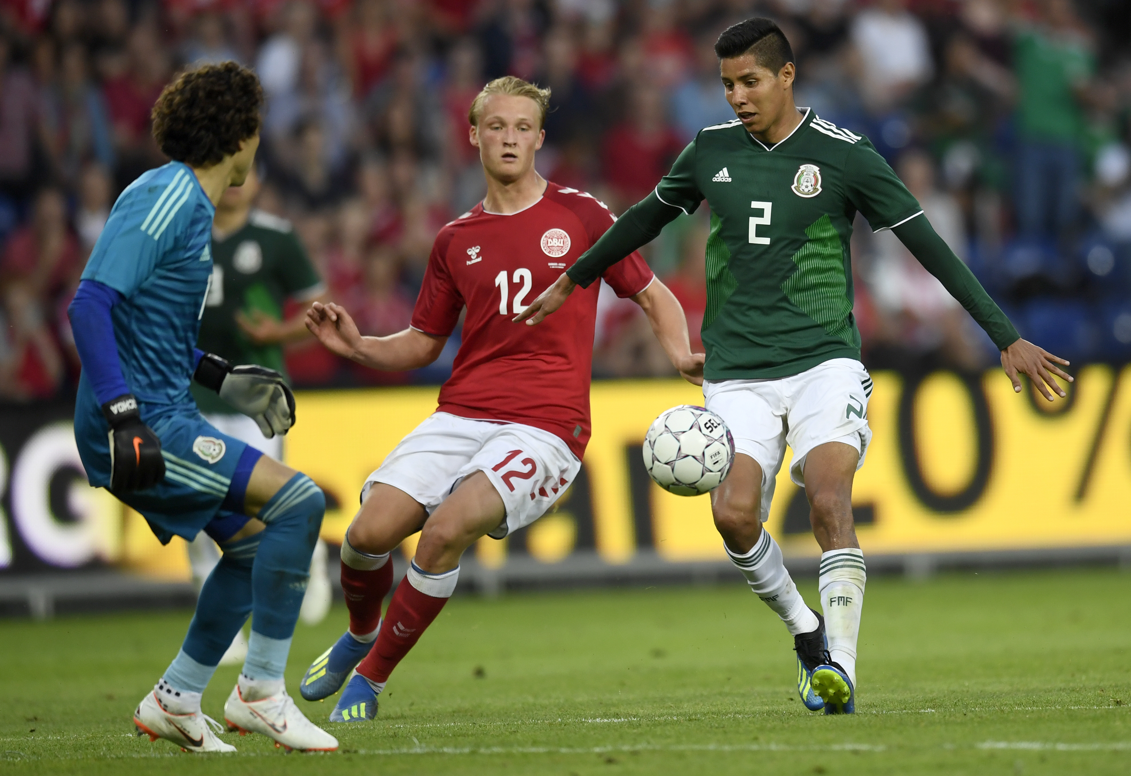 A football match between Denmark and Mexico