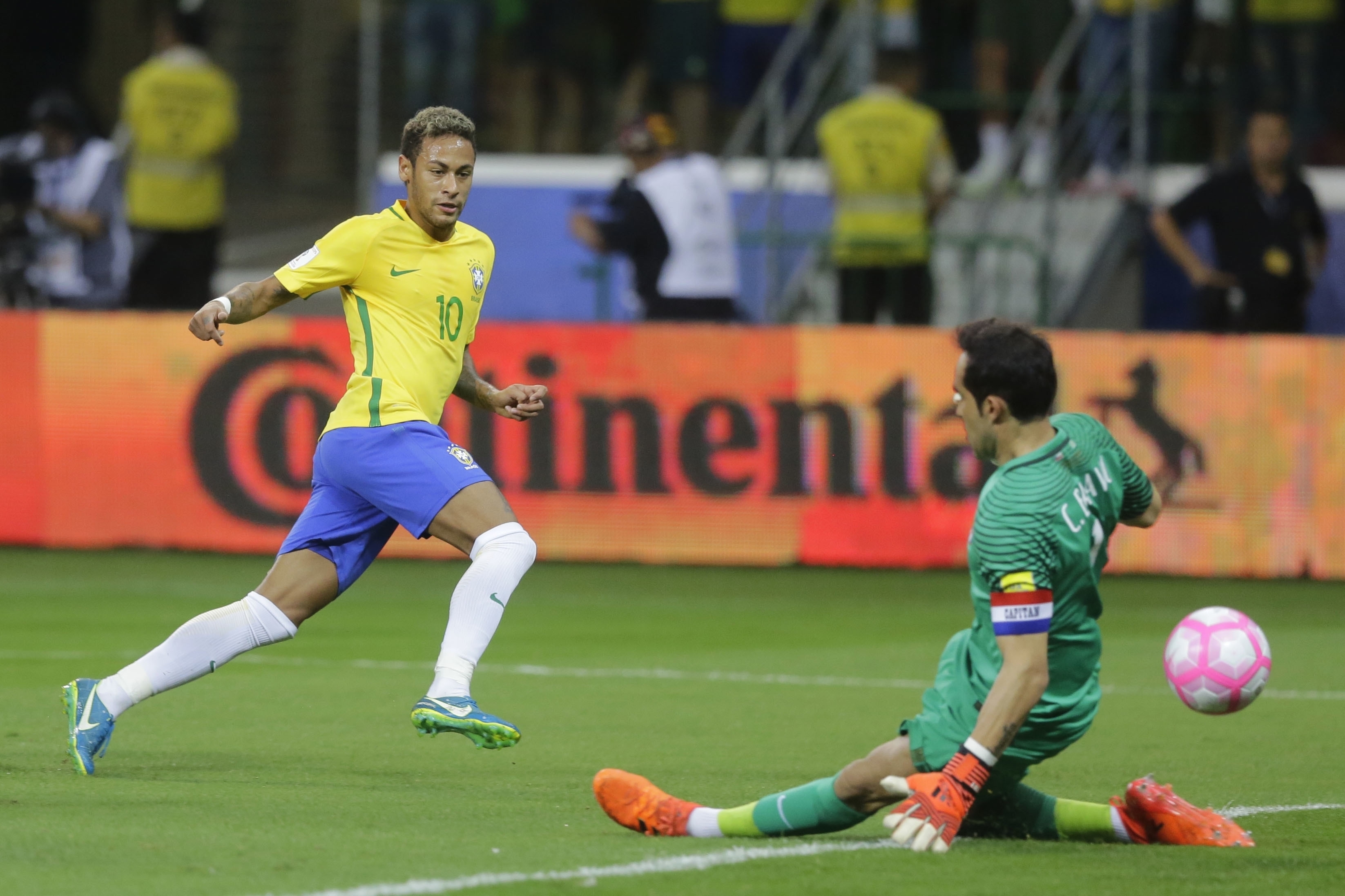 Brazil's Neymar kicks the ball past Chile goalkeeper Claudio Bravo