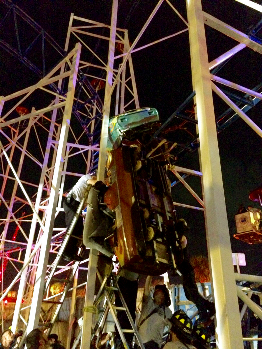 Emergency crews work on a derailed roller coaster car in Florida