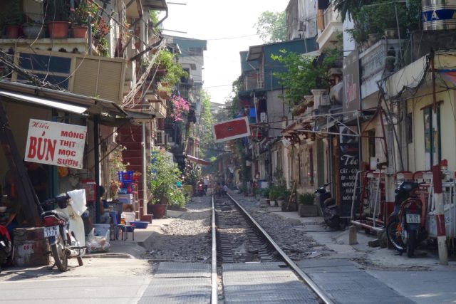 Sections of Vietnam's railway squeeze past buildings in Hanoi (Ed Elliot/PA)