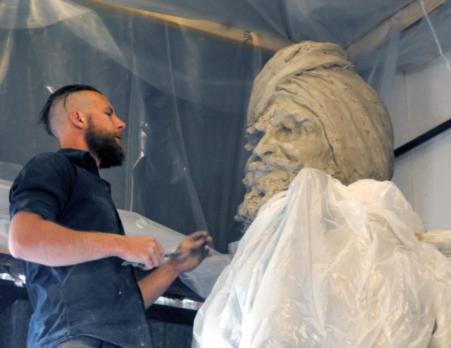 Sculptor Luke Perry working on Sikh soldier statue