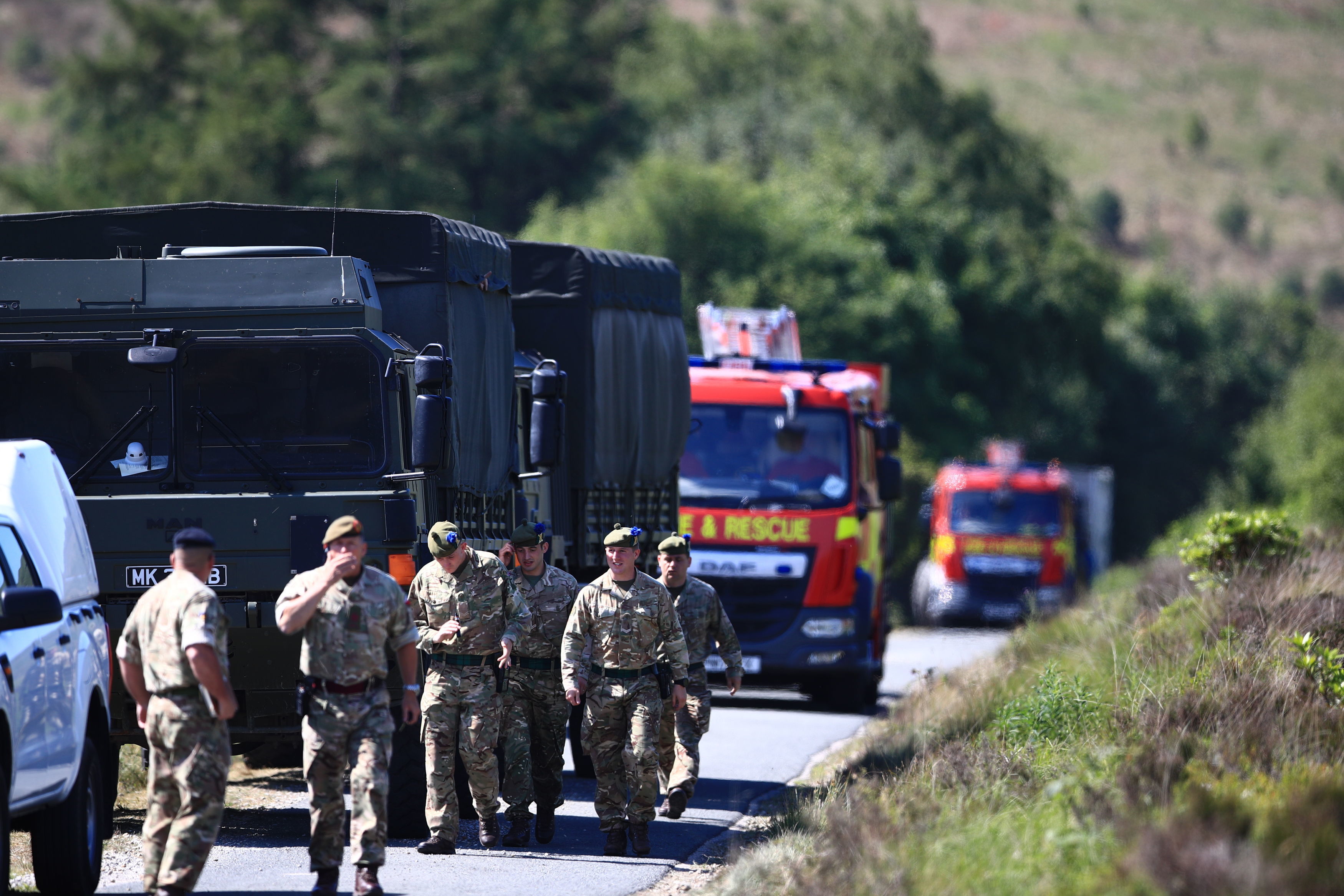 Military personnel arrive to assist as firefighters tackle a wildfire on Saddleworth Moor 