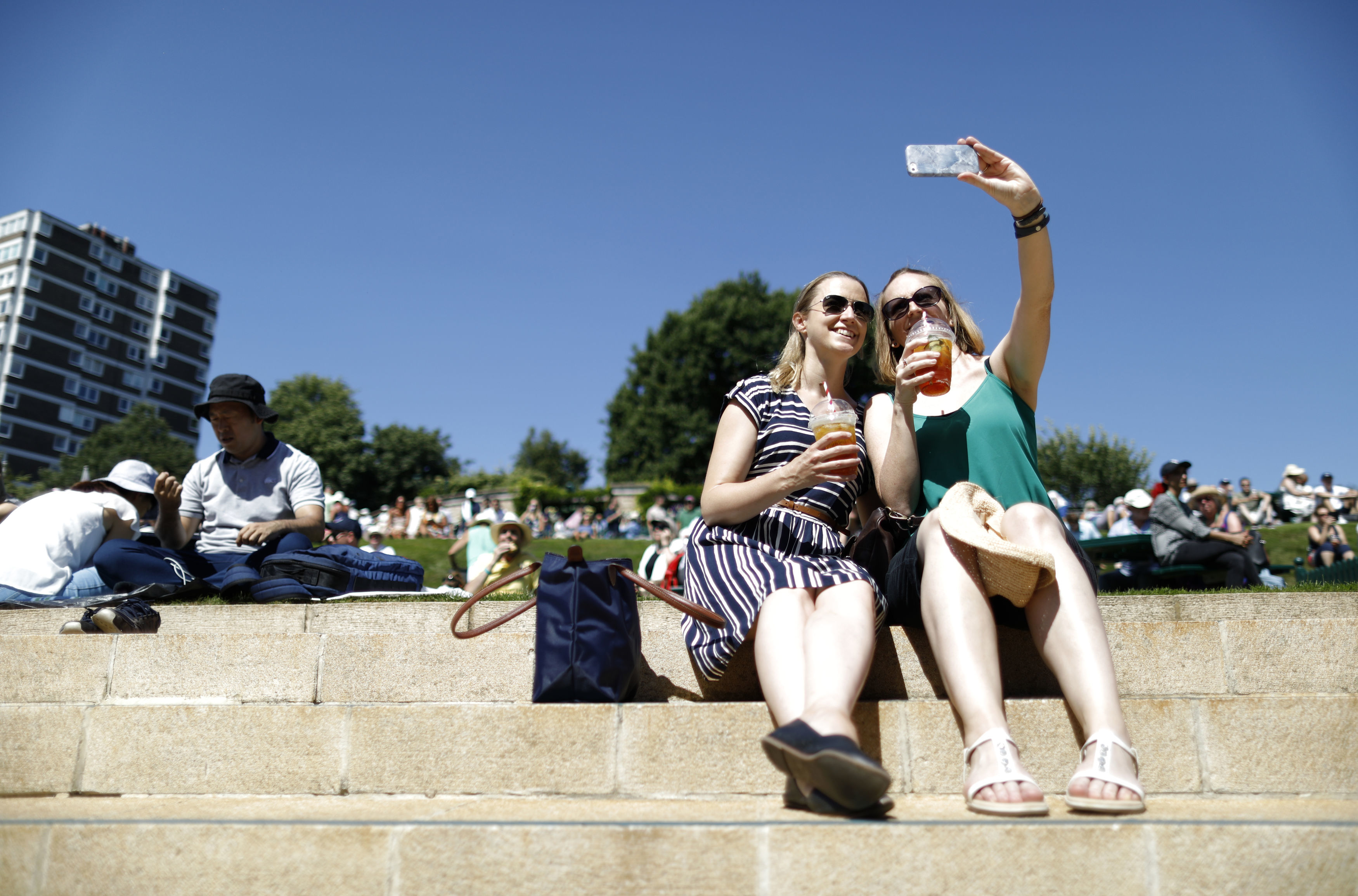 Spectators take a selfie on day one of the Wimbledon Championships at the All England Lawn Tennis and Croquet Club
