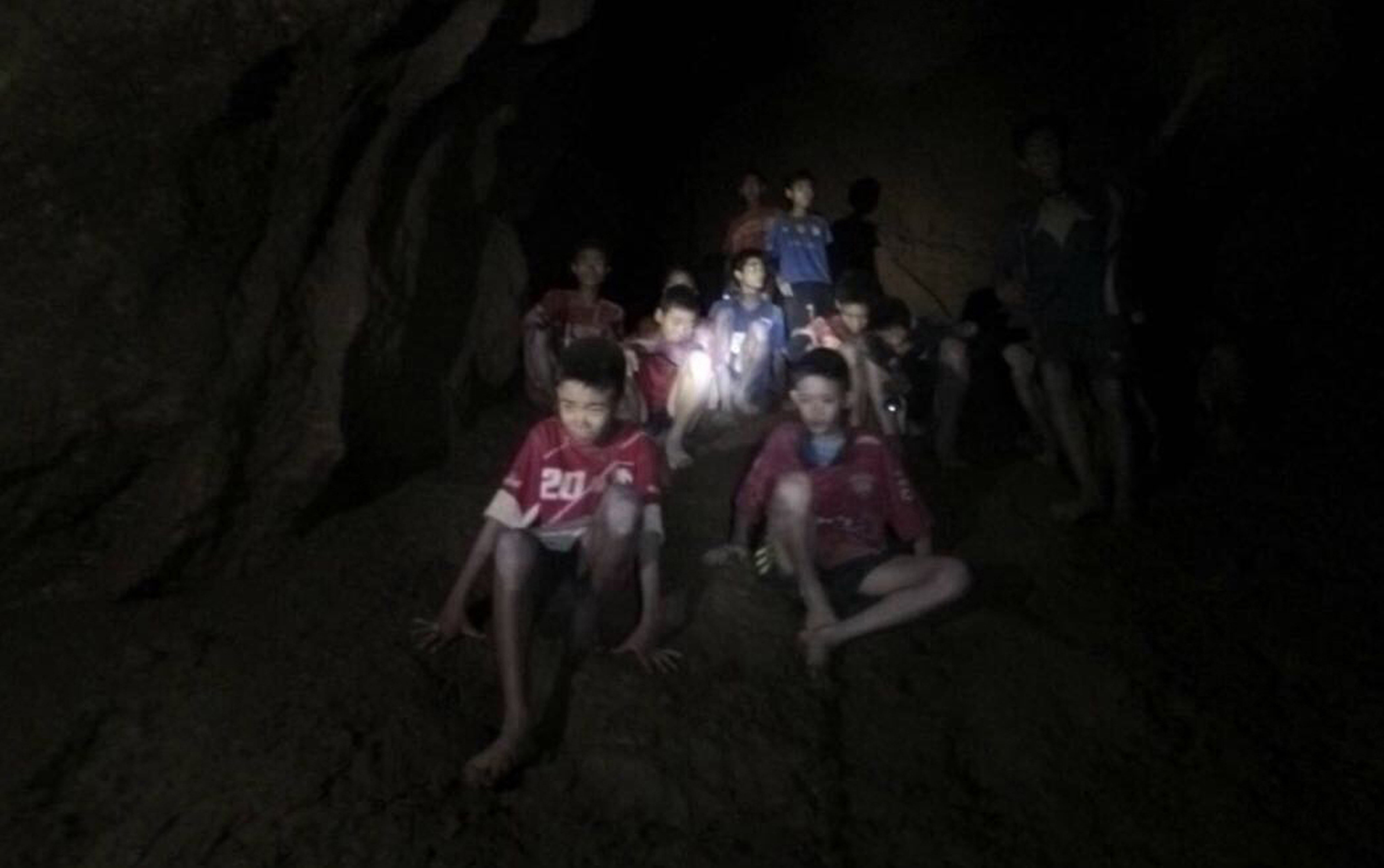 Twelve boys and their football coach in the partially flooded cave in Thailand