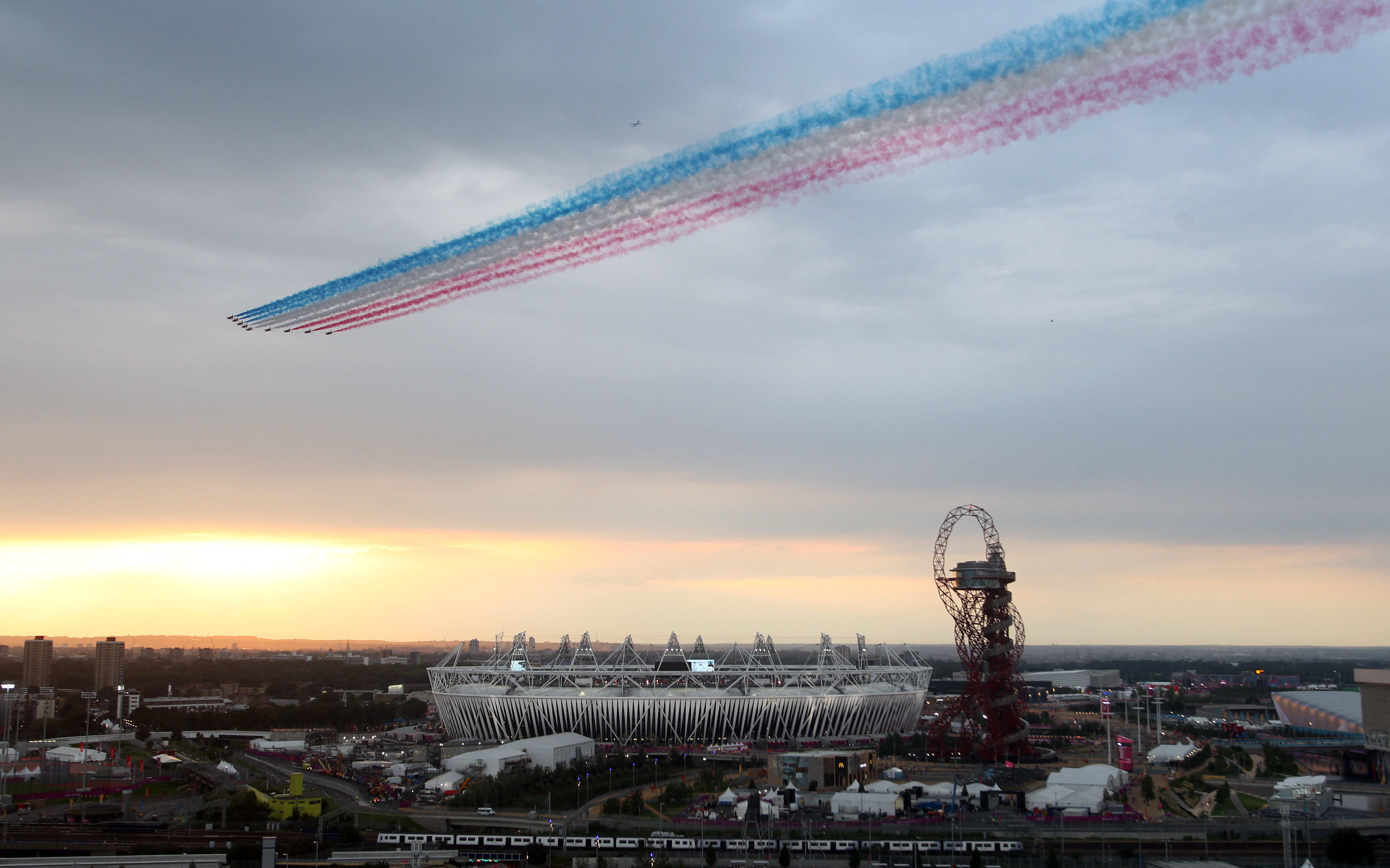 The Red Arrows perform a flypast over the Olympic Park in London 