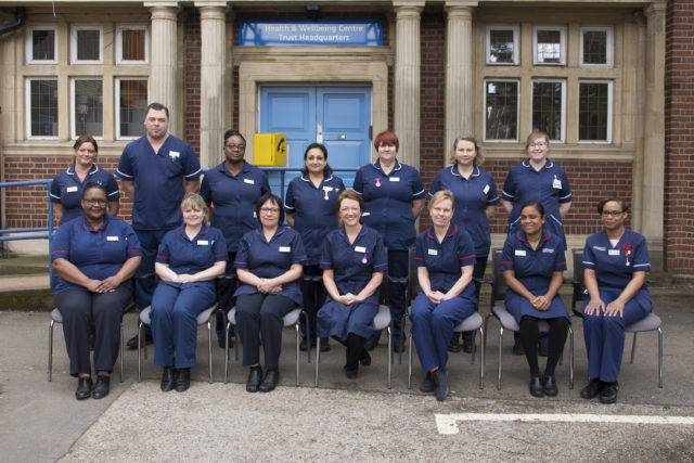 Staff at Sandwell the and West Birmingham Trust pictured outside Sandwell Hospital for a photo emulating a 1927 image found in a broom cupboard.