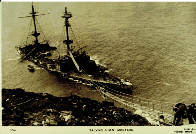 HMS Montagu could not be saved and had to be salvaged where she lay on the rocks ( Historic England/PA)