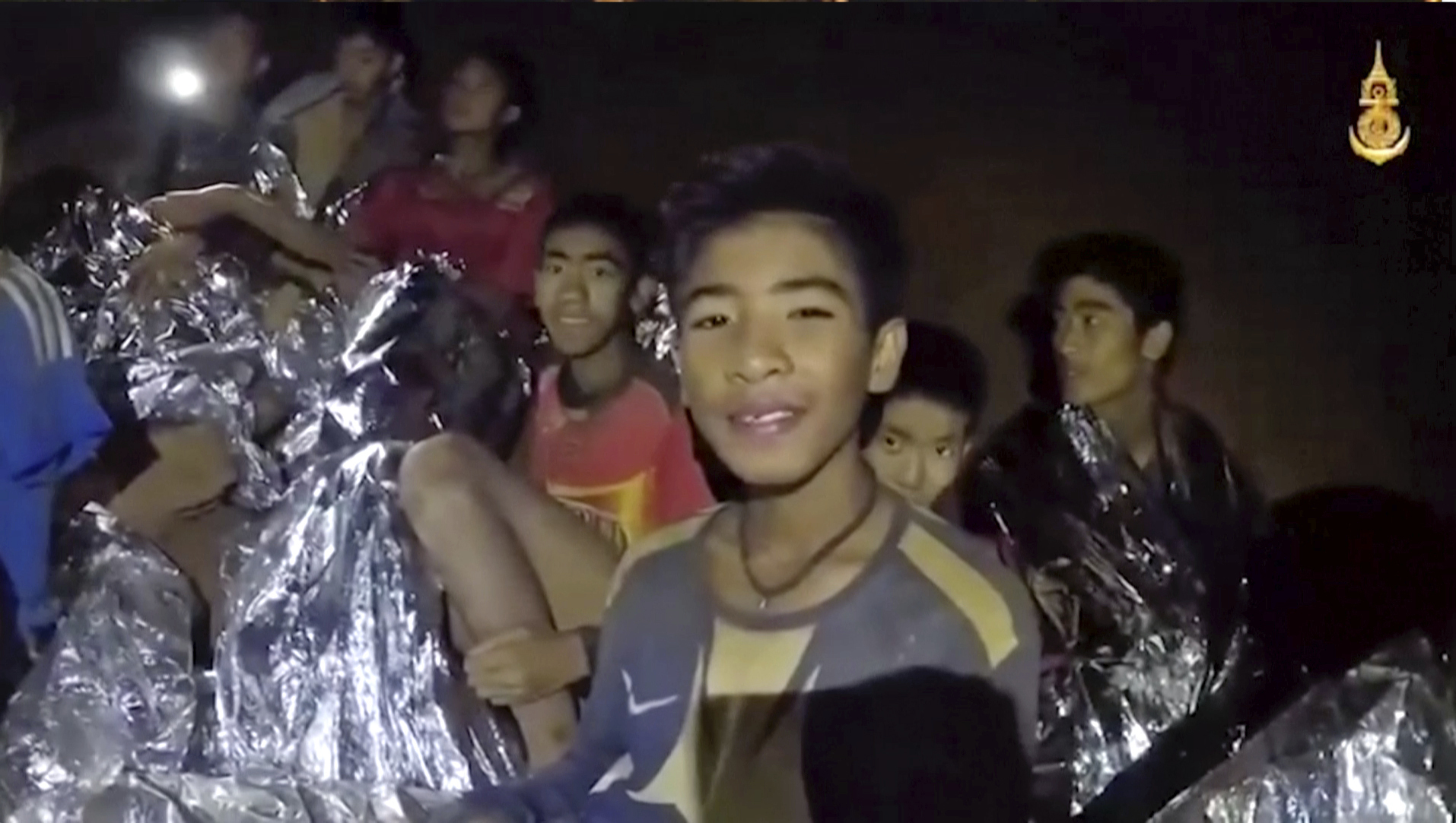 Boys trapped in a Thai cave smile as a navy Seal medic helps