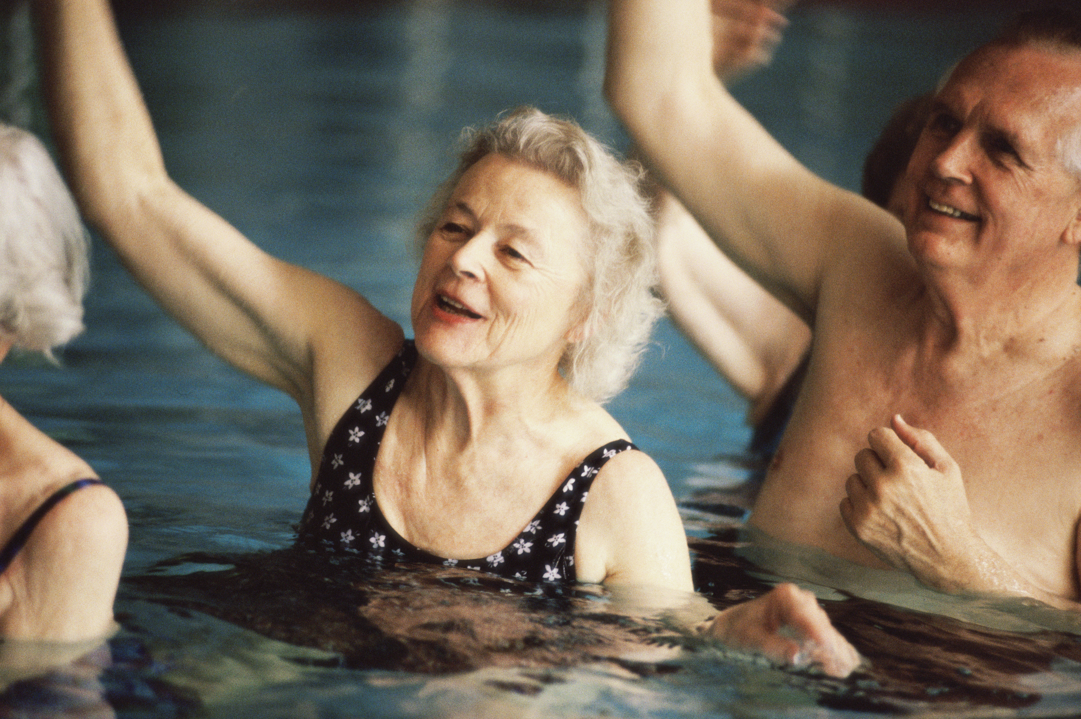 Group of senior people performing water aerobics in a swimming pool