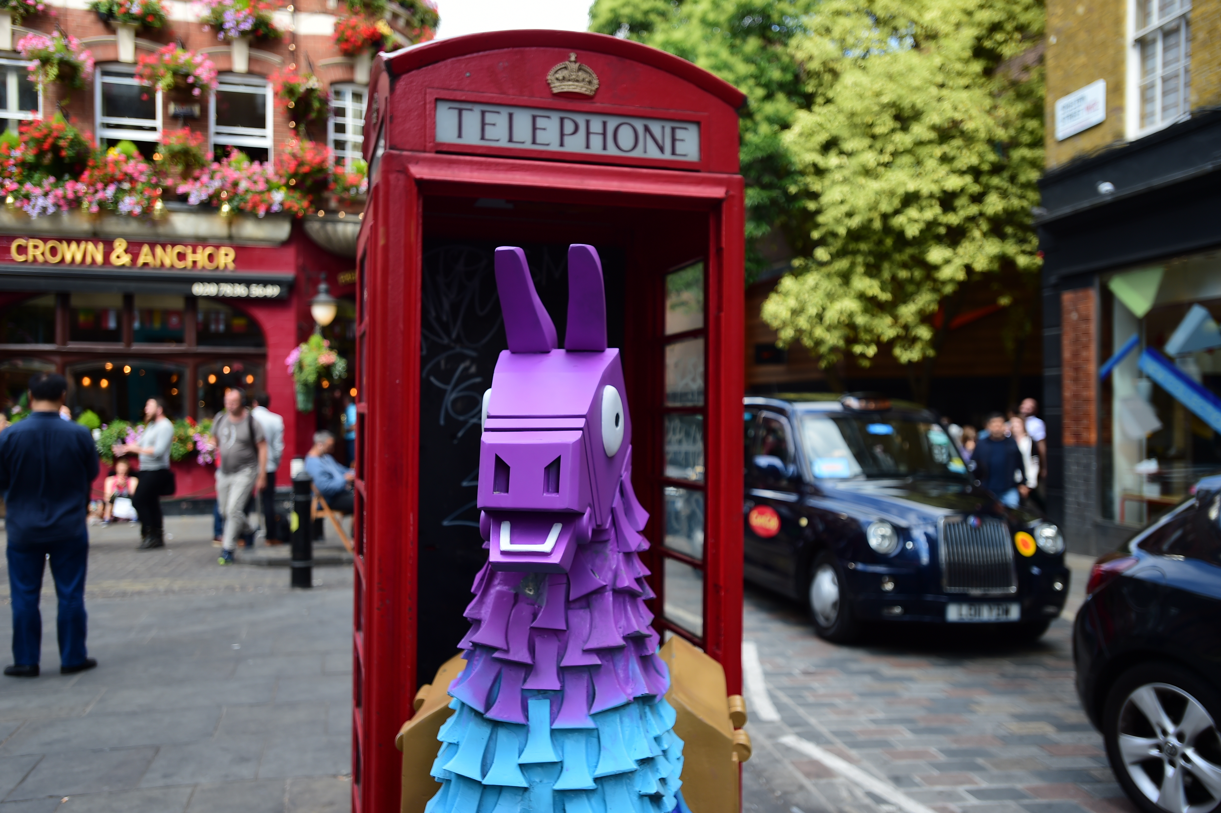 a fortnite loot llama in a red telephone box on neal street in covent garden - fortnite london ontario