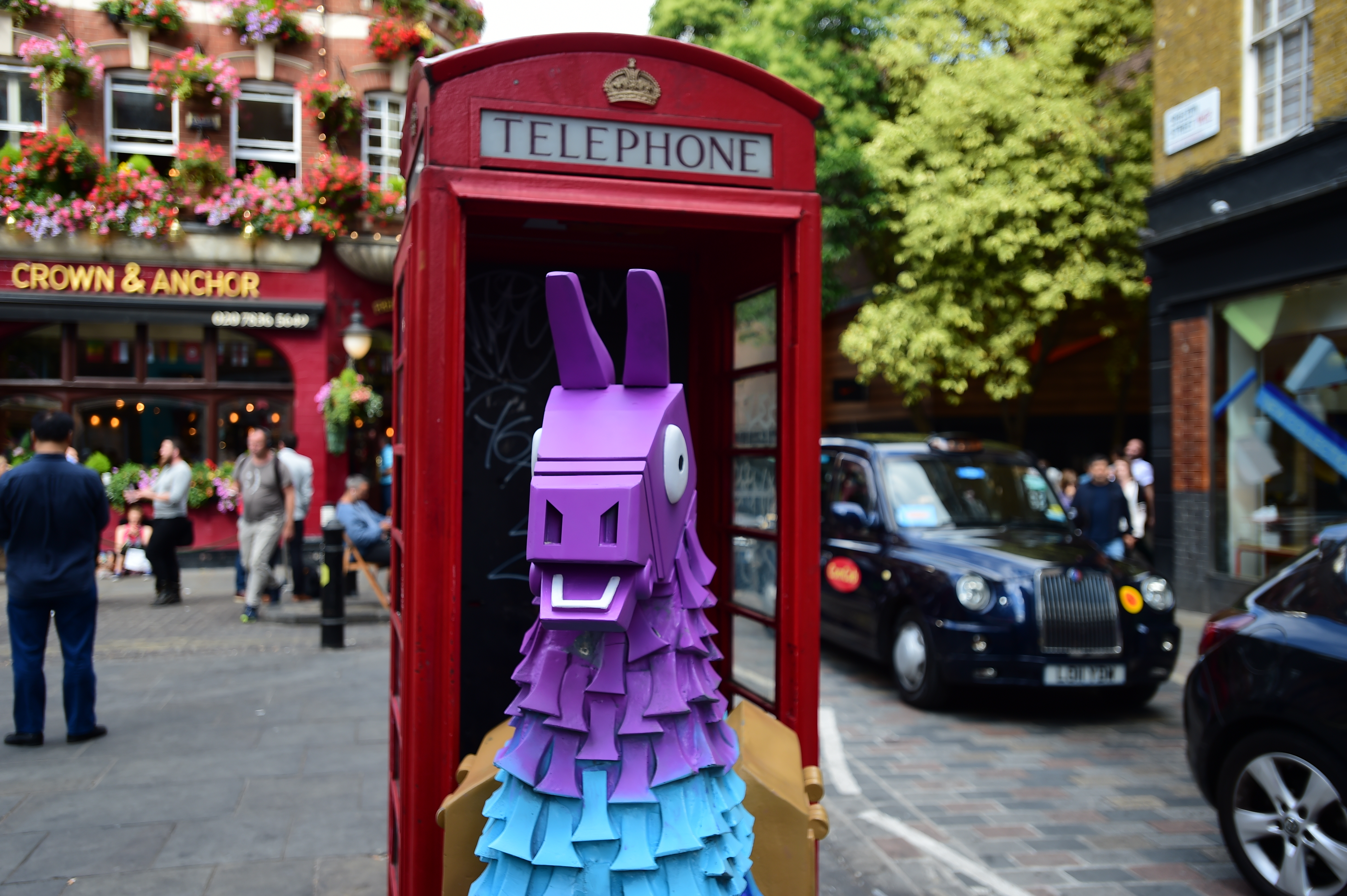 a fortnite loot llama in a red telephone box on neal street in covent garden - how to build fortnite llama