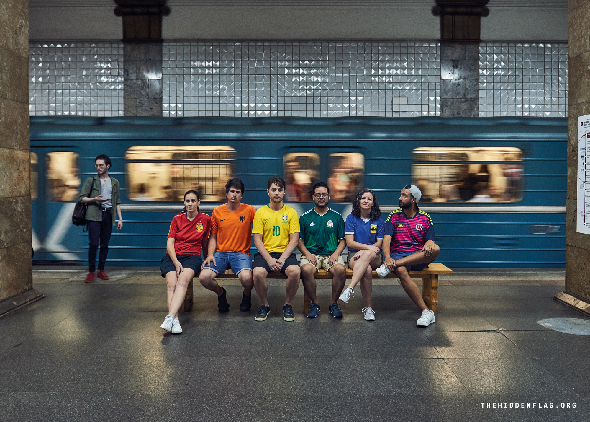 Six activists wear six football shirts to create the colours of the rainbow flag
