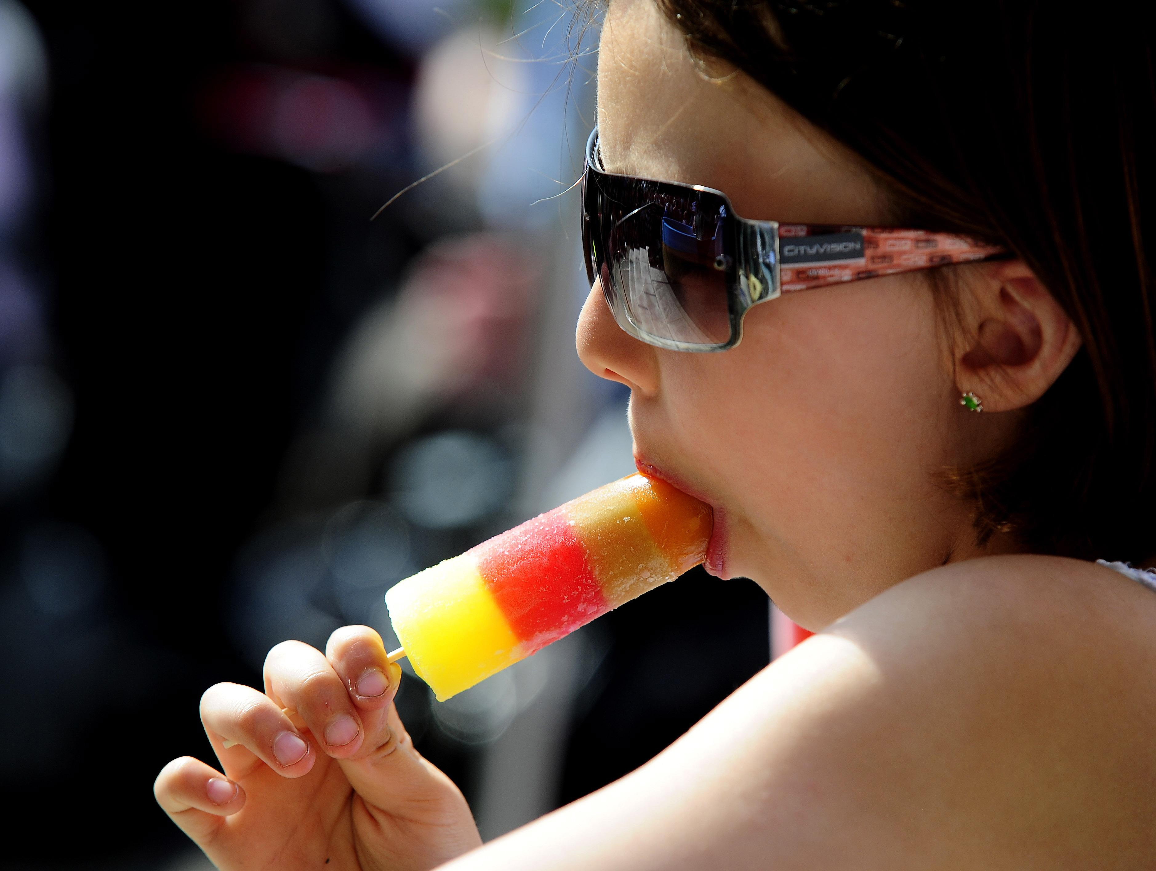 A member of the public keeps cool with a Fruit Pastille ice lolly (PA Archive)