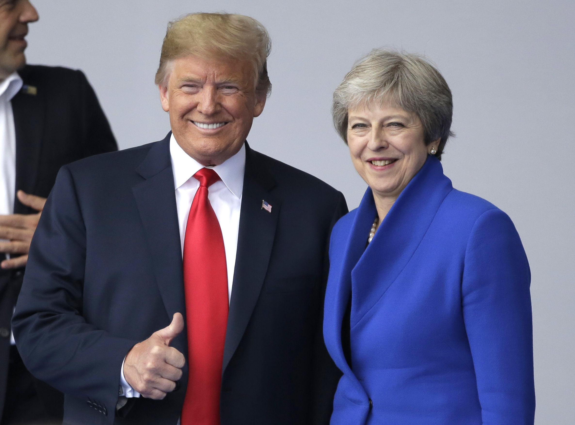 Donald Trump talks to Theresa May during a summit of heads of state and government at Nato headquarters in Brussels 