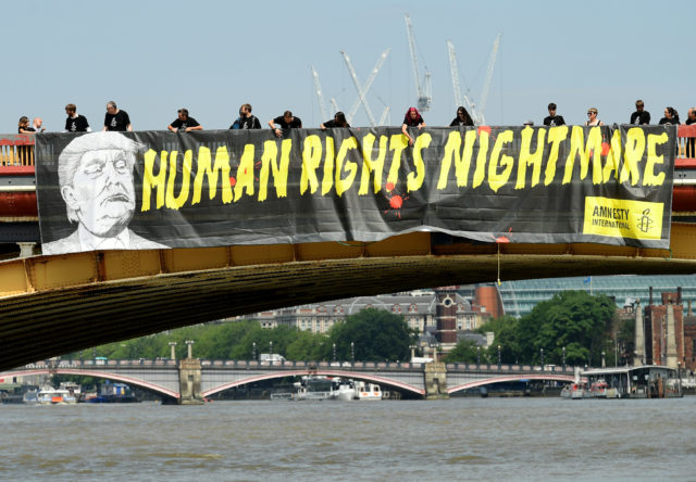 Amnesty International unveil a banner on the Vauxhall Bridge in London in protest against the visit of US President Donald Trump to the UK