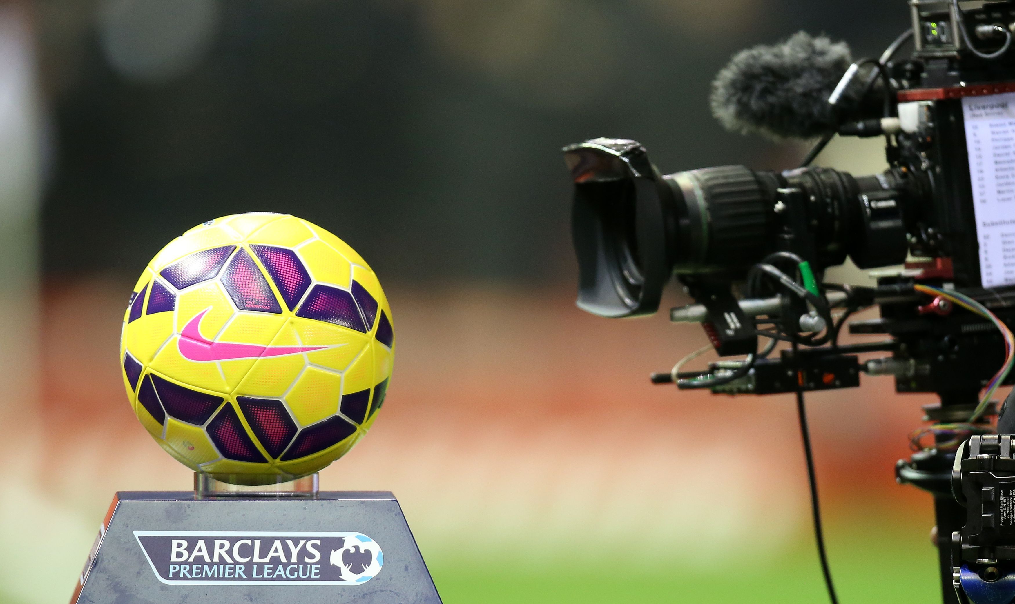 A TV camera filming a close up of a Premier League football