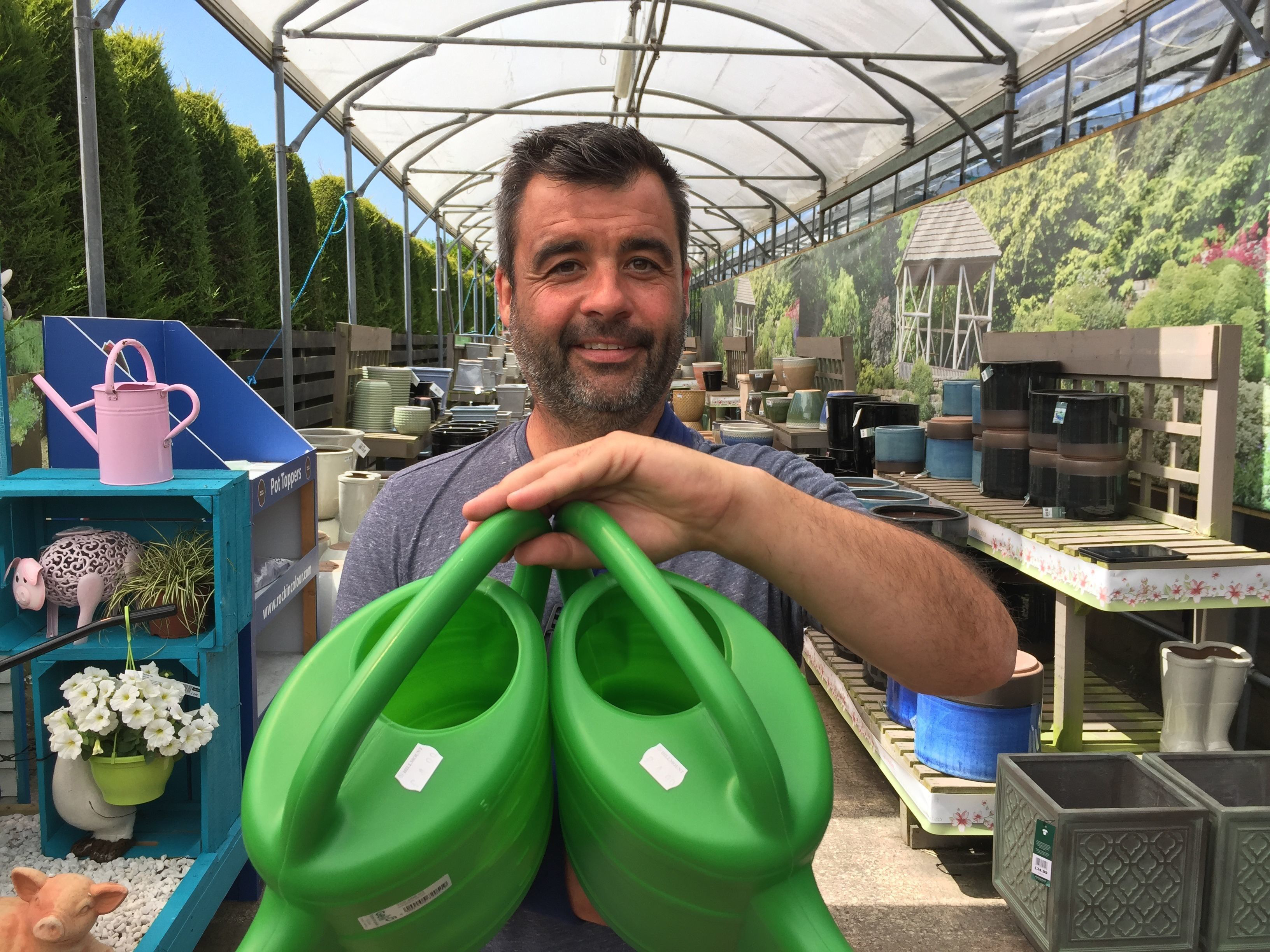 Man holding watering cans (David Young/PA)