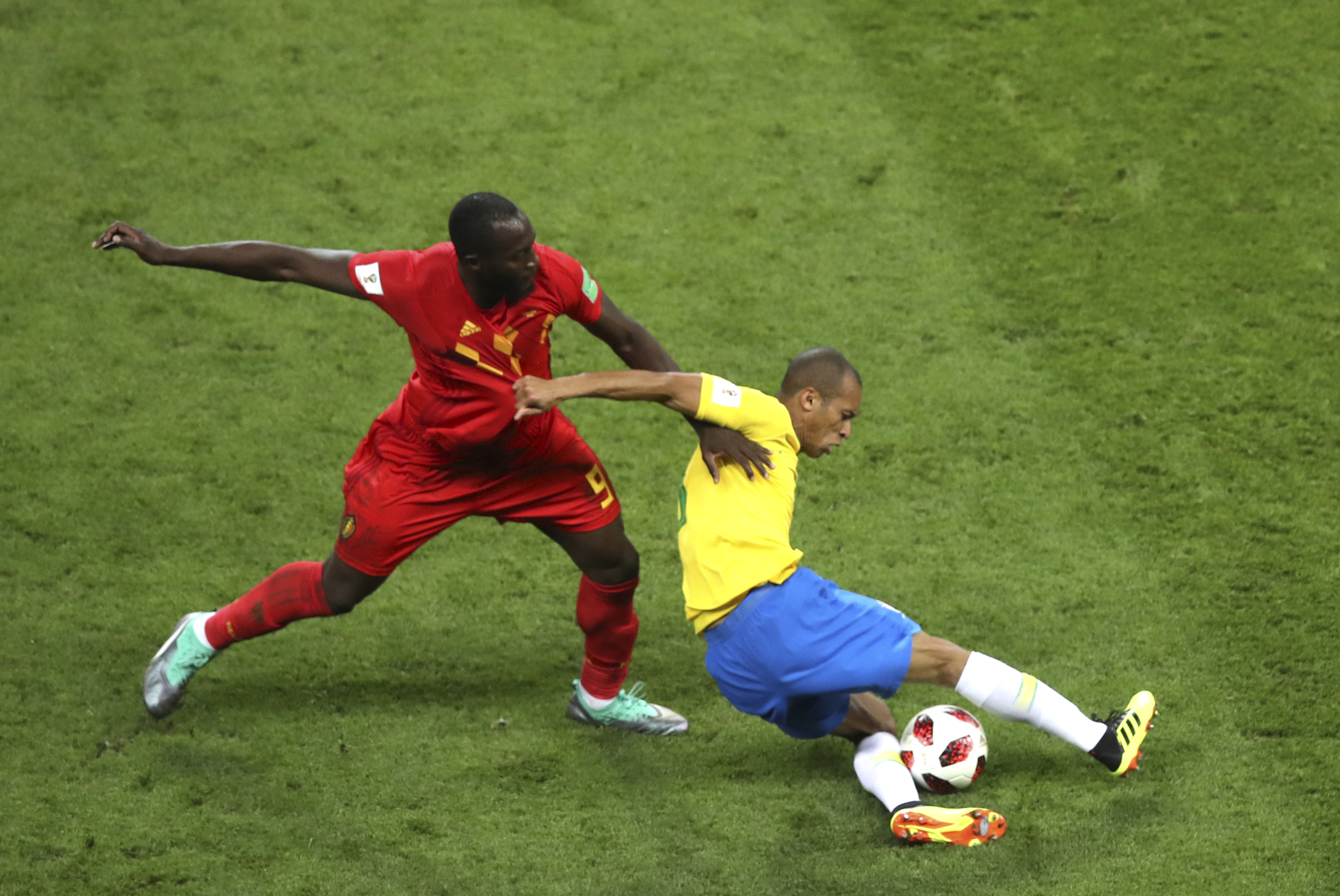 Belgium's Romelu Lukaku and Brazil's Miranda challenge for the ball at the 2018 World Cup