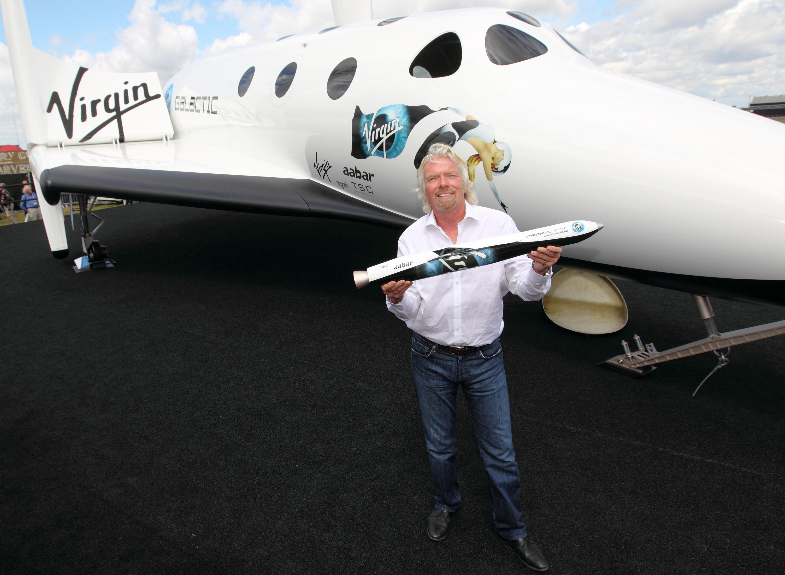 Sir Richard Branson with his Virgin Galactic Space craft at the Farnborough International Airshow 2012 in Hampshire. (Steve Parson/PA)