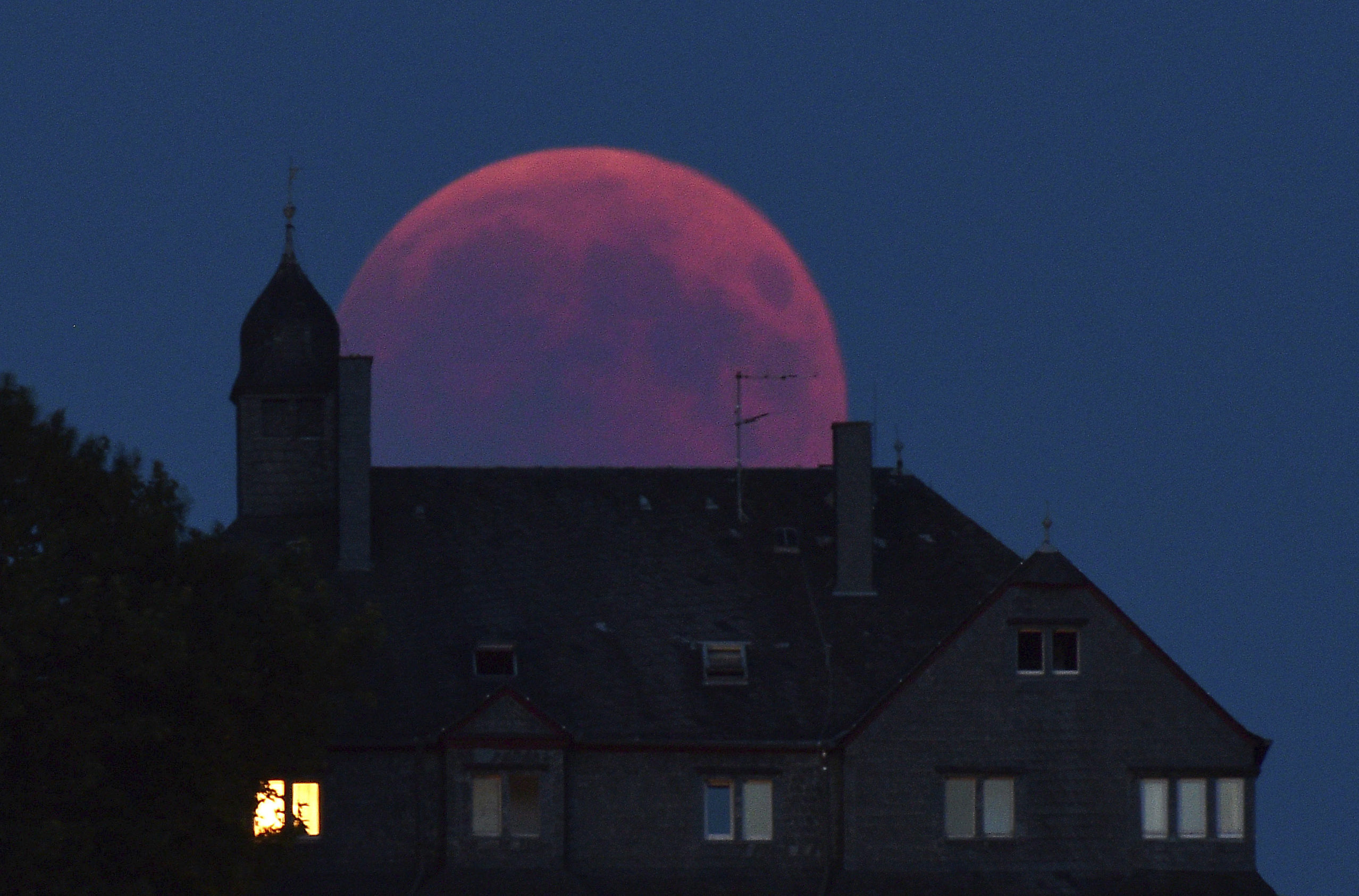 The moon turns red during a total lunar eclipse in Germany