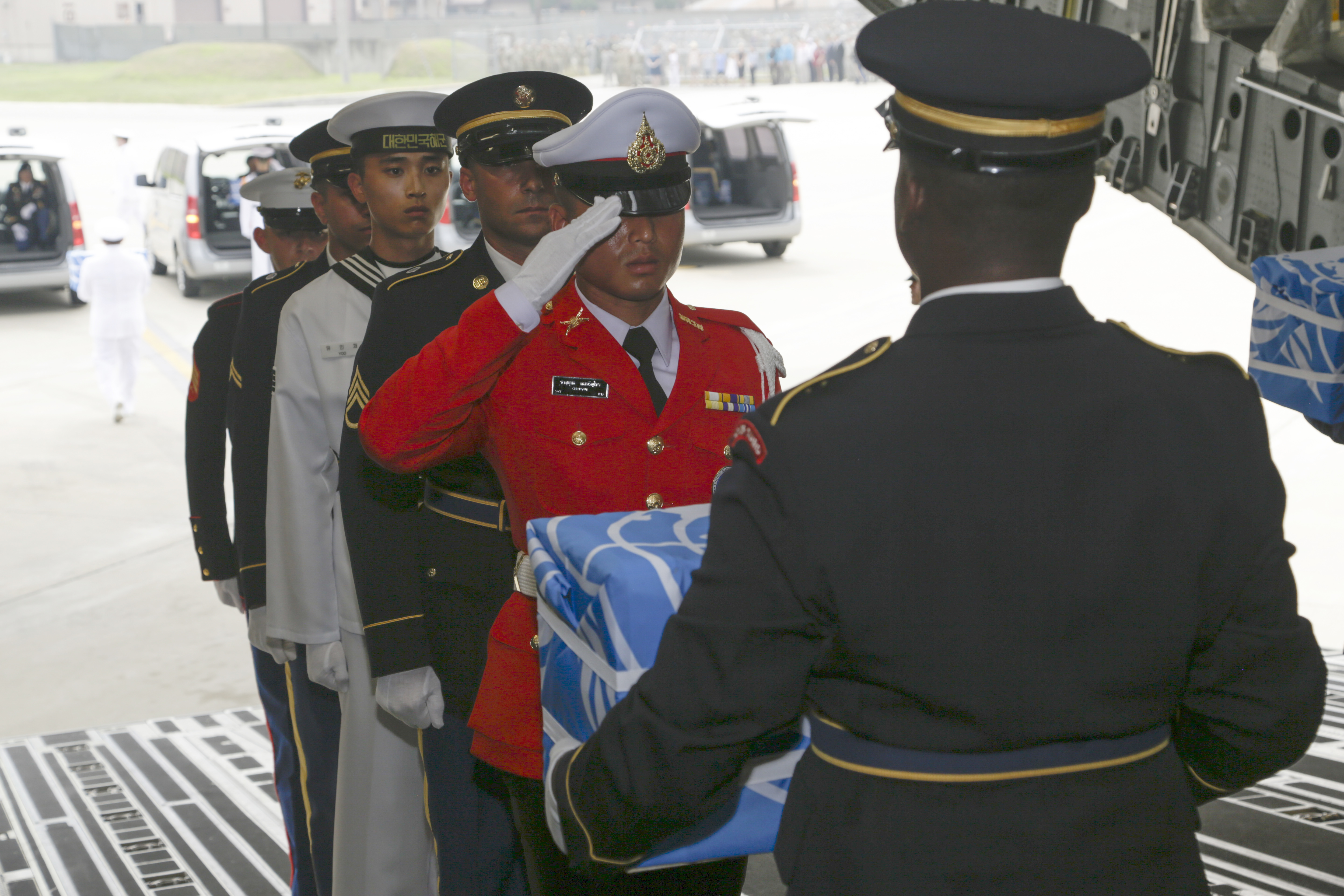 United Nations Honour Guard members carry boxes believed to contain the remains of US servicemen killed during the Korean War 