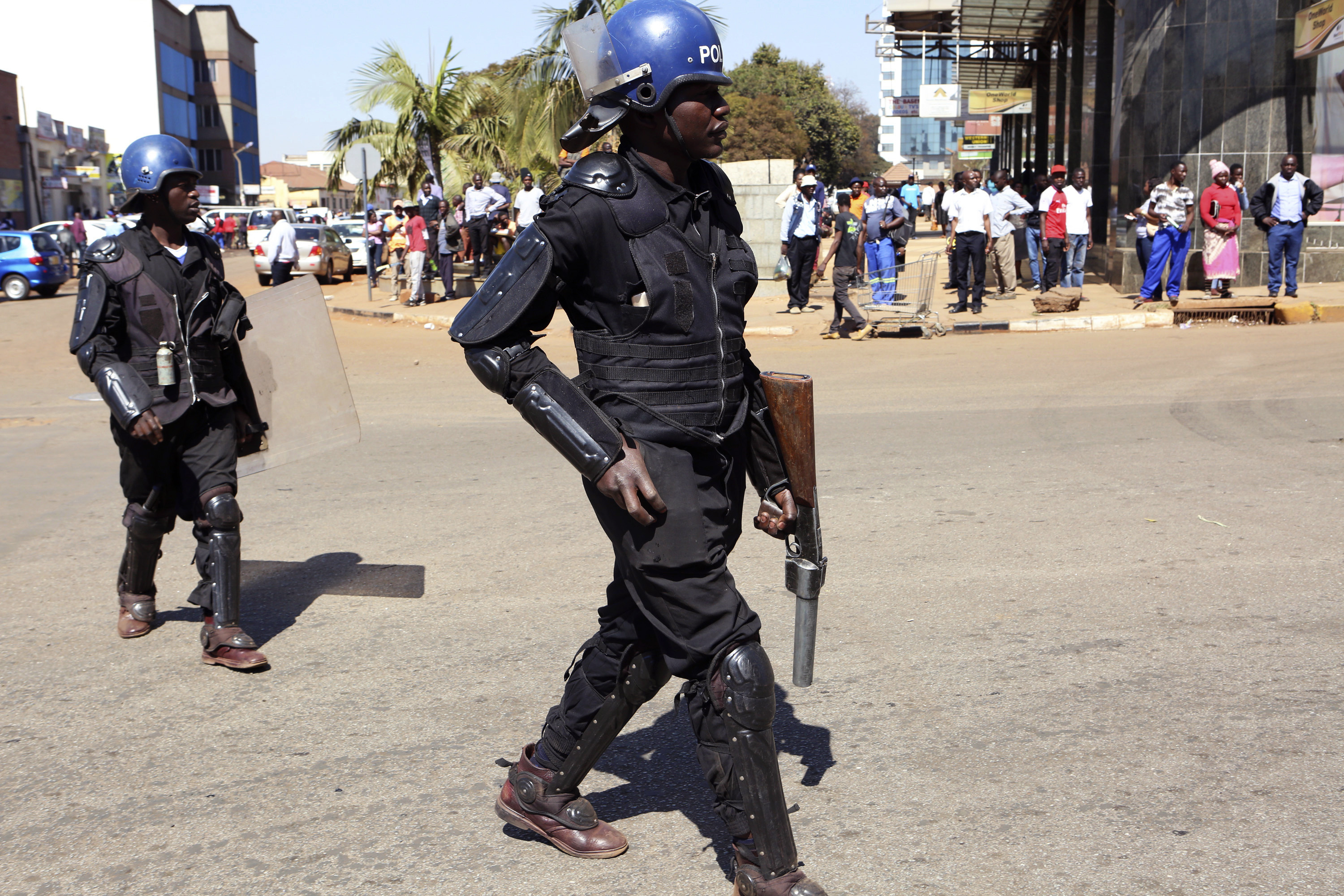 Armed riot police patrol outside the Zimbabwe Electoral Commission offices in Harare 