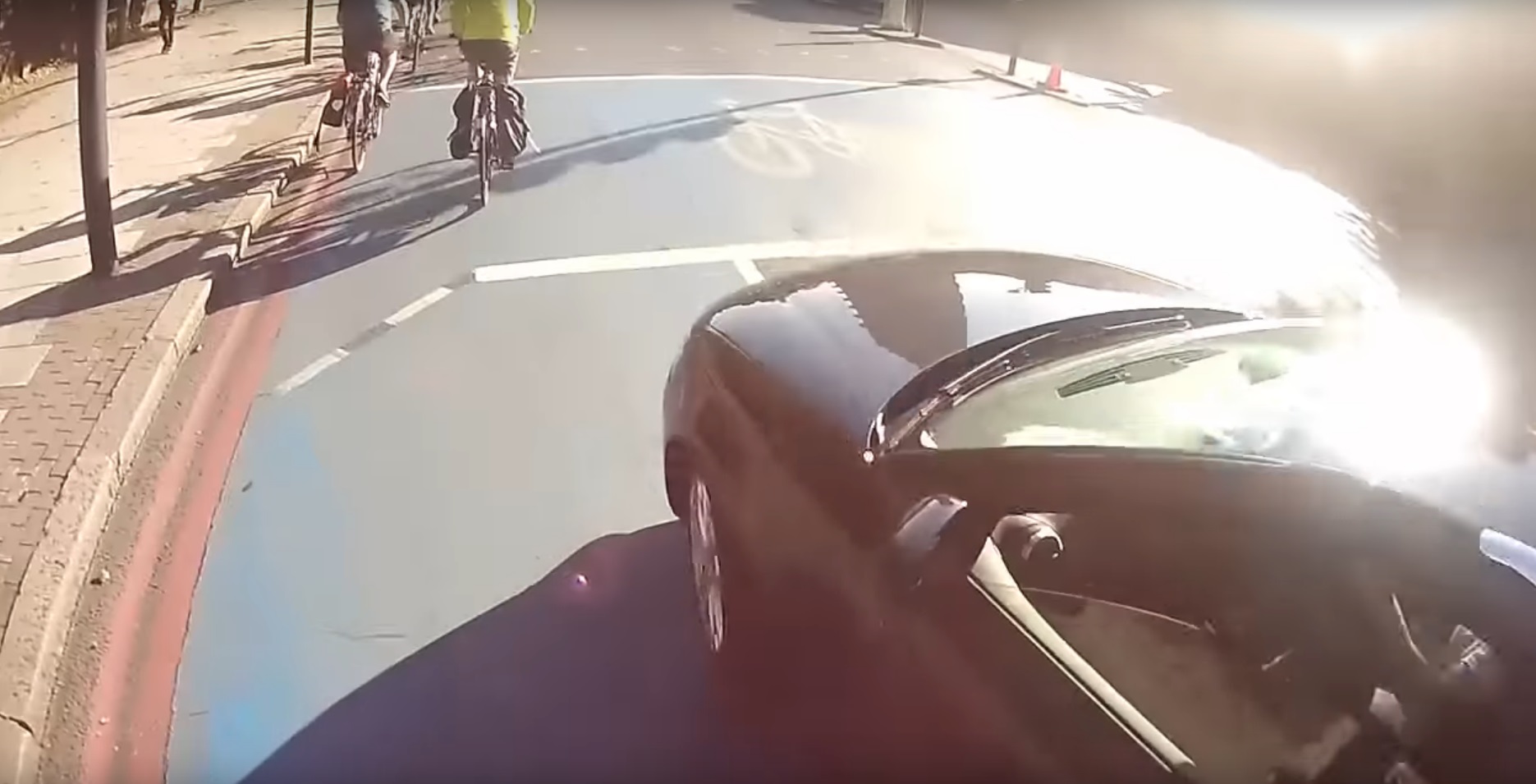 The driver swerves in front of the cyclist