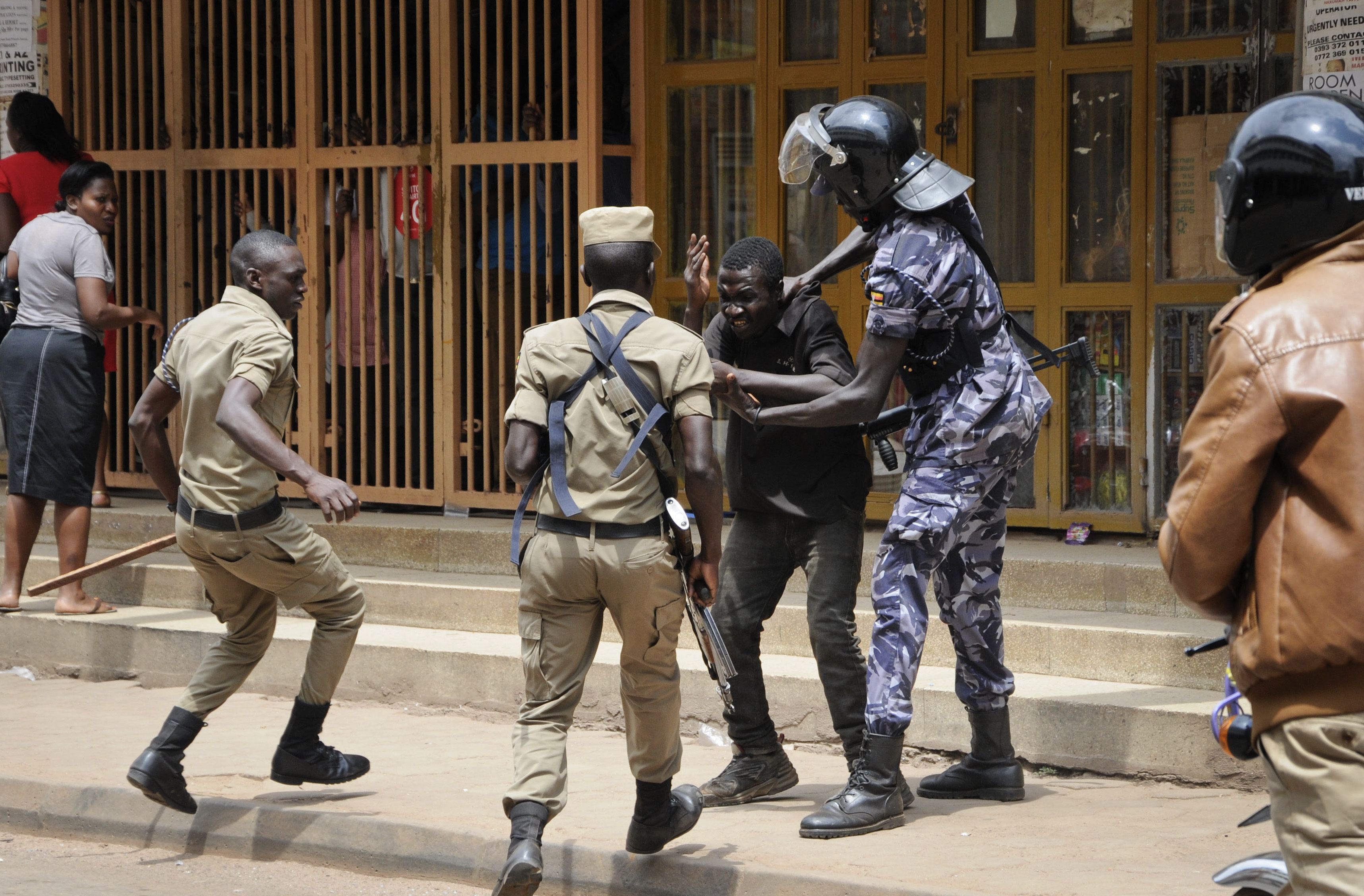 Ugandan security forces detain a protester in Kampala