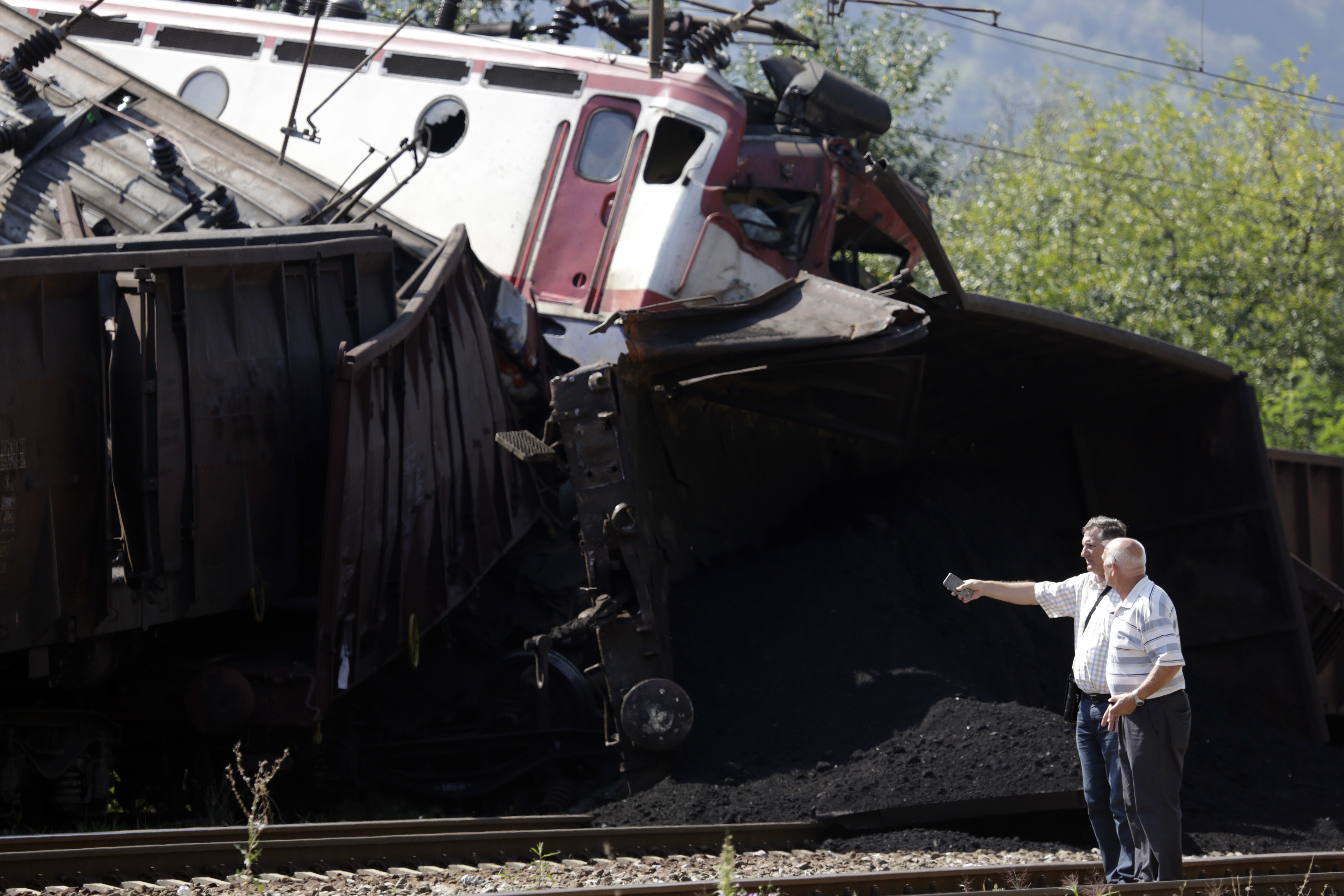 People at the scene where two cargo trains collided in Bosnia