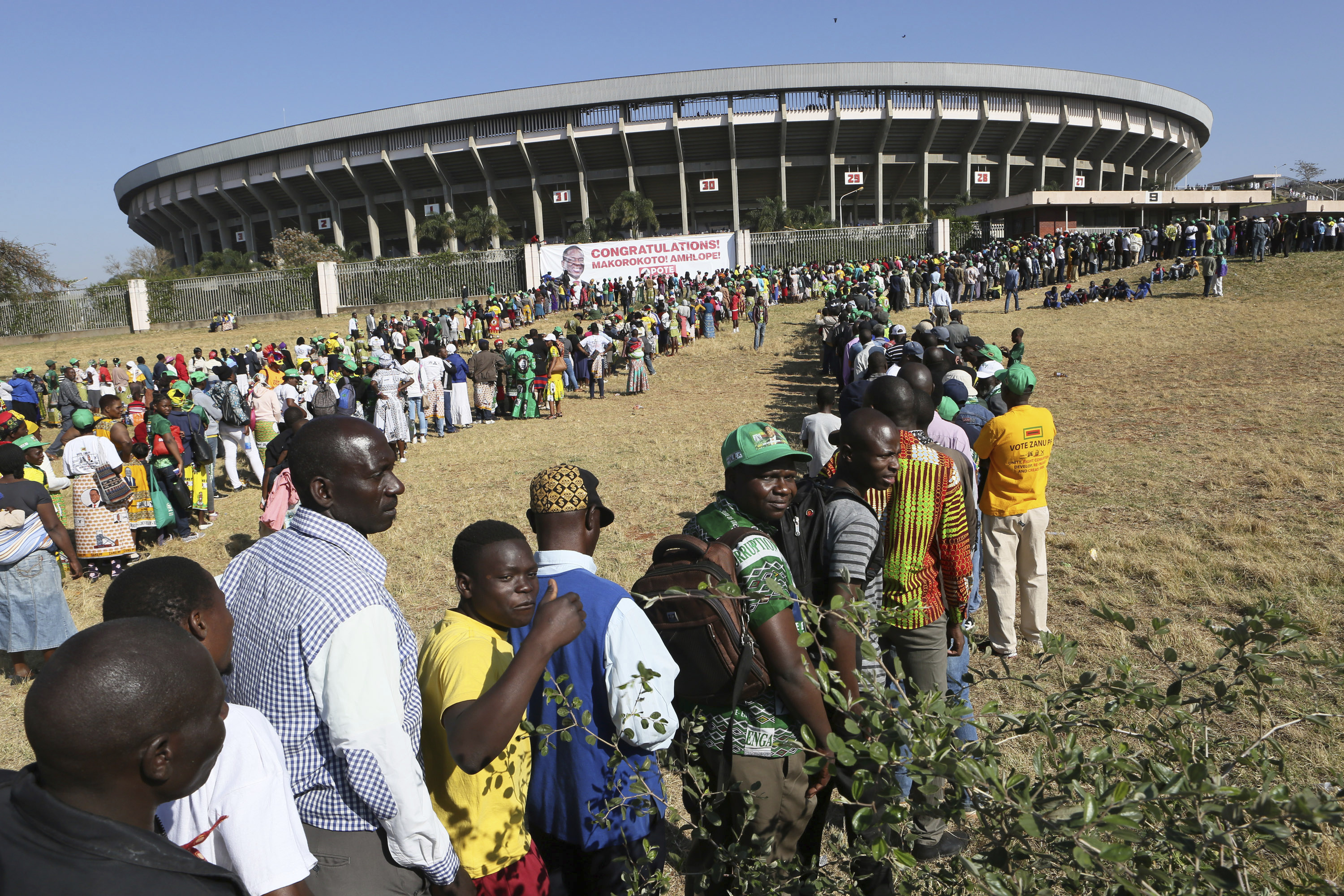 People queue for the inauguration ceremony of Zimbabwean President Emmerson Mnangagwa, at the National Sports Stadium in Harare