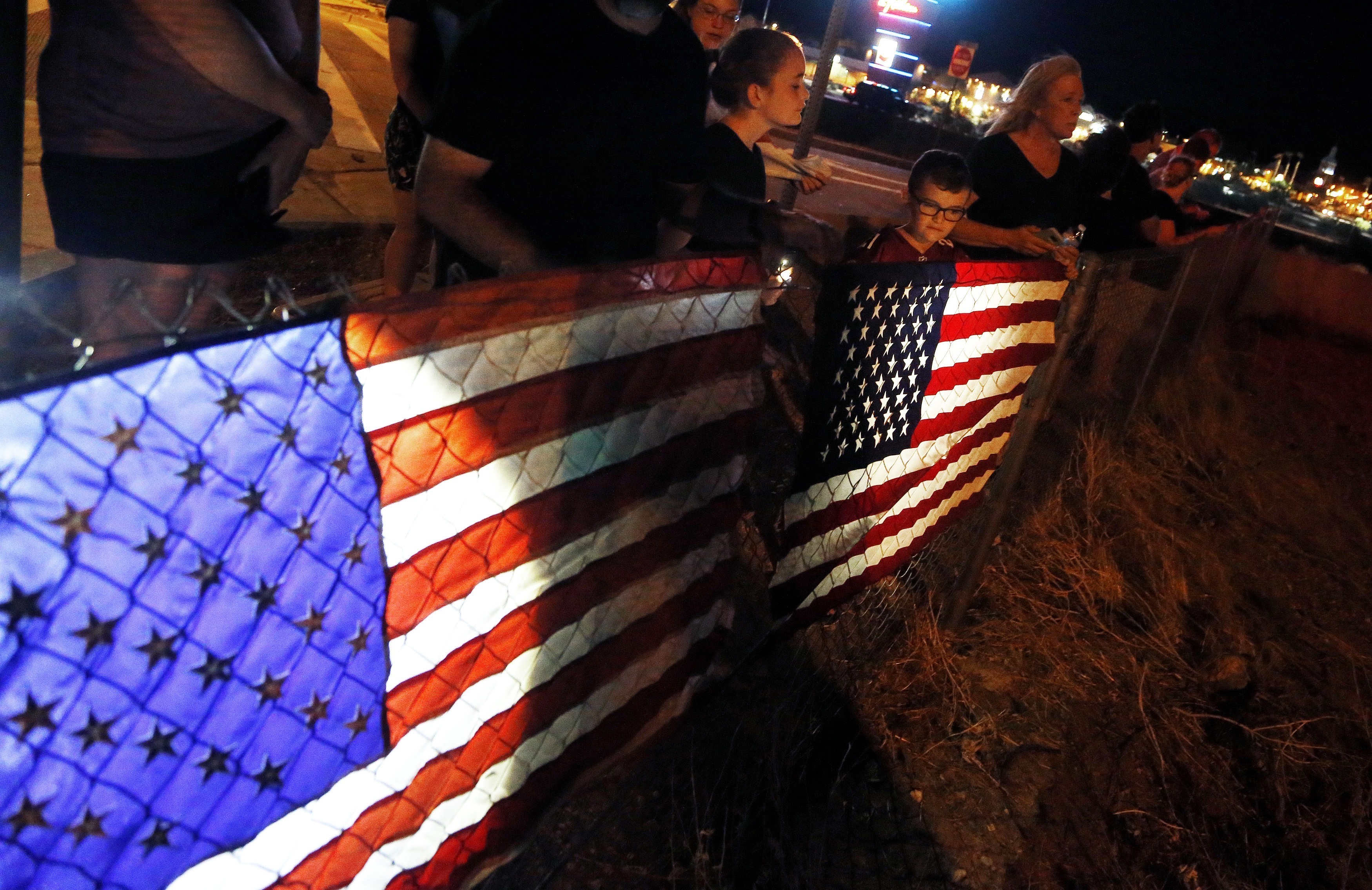 People line Interstate 17 for the procession with the hearse carrying the late Arizona senator John McCain