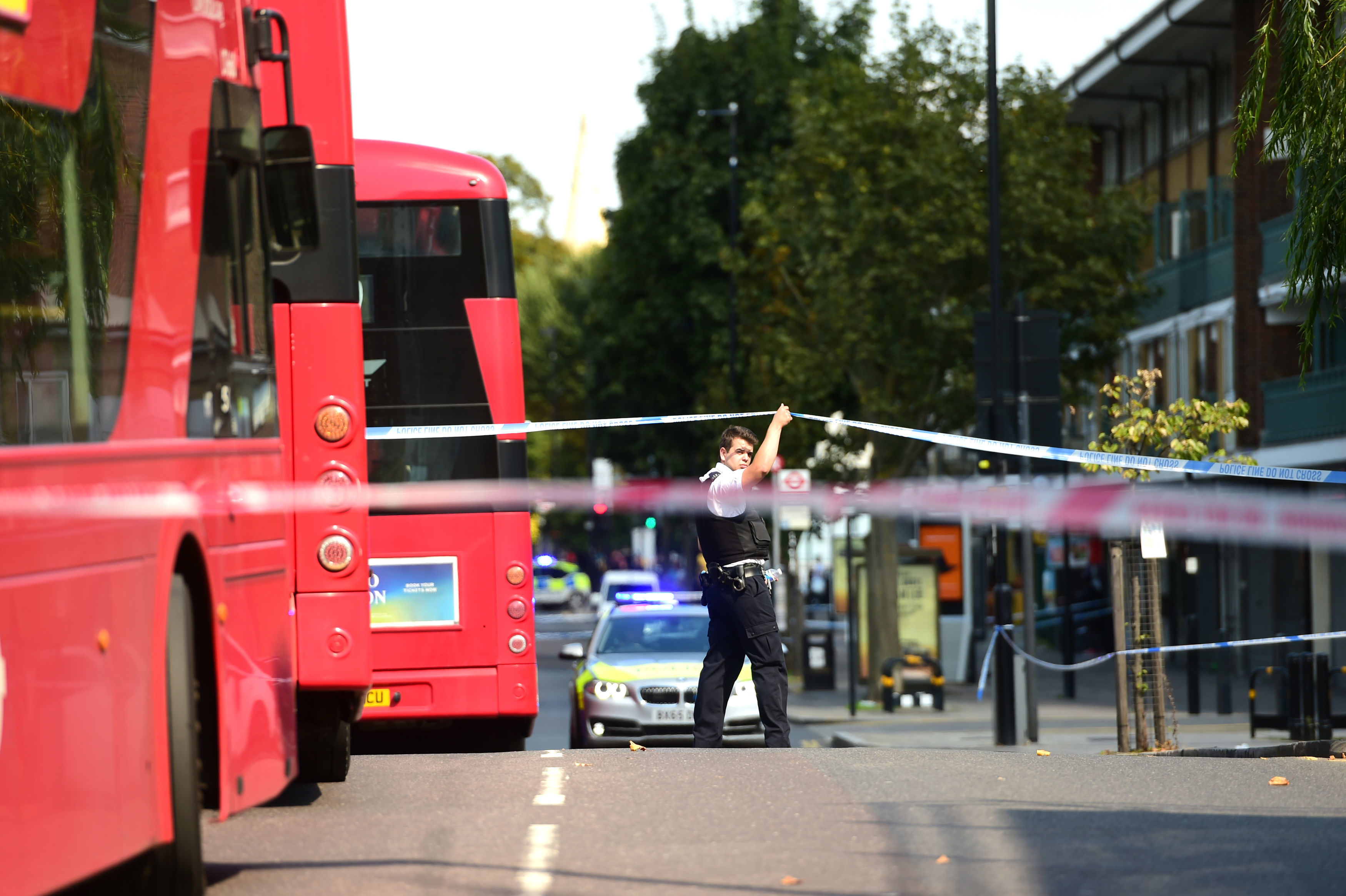 A police officer cordons off the area on the Caledonian Road in Islington