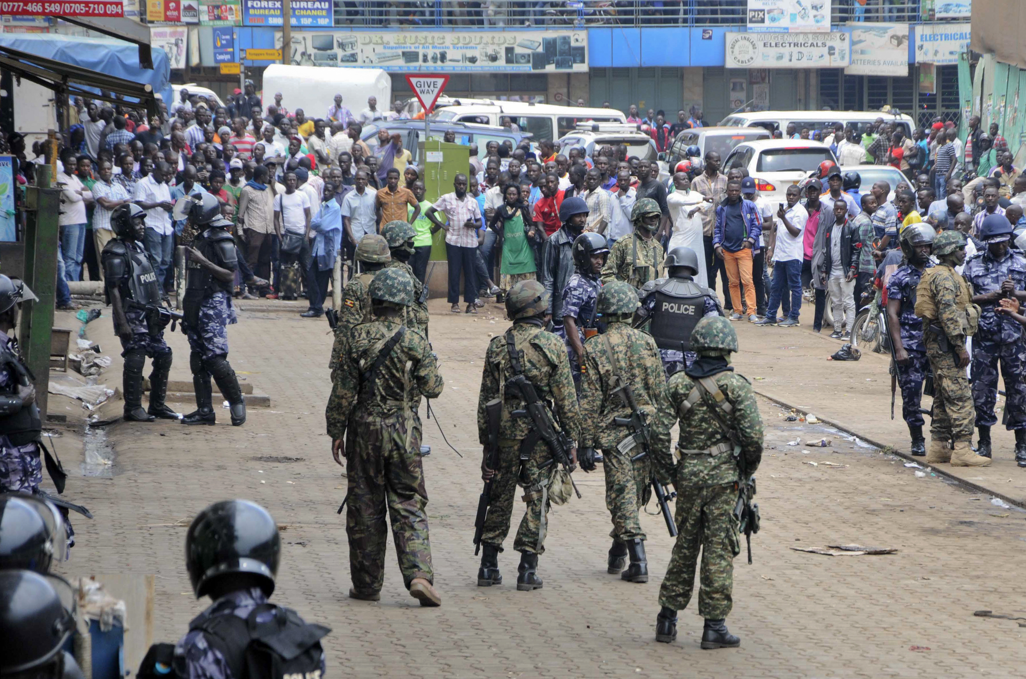 Ugandan army soldiers stand in front of a crowd during protests