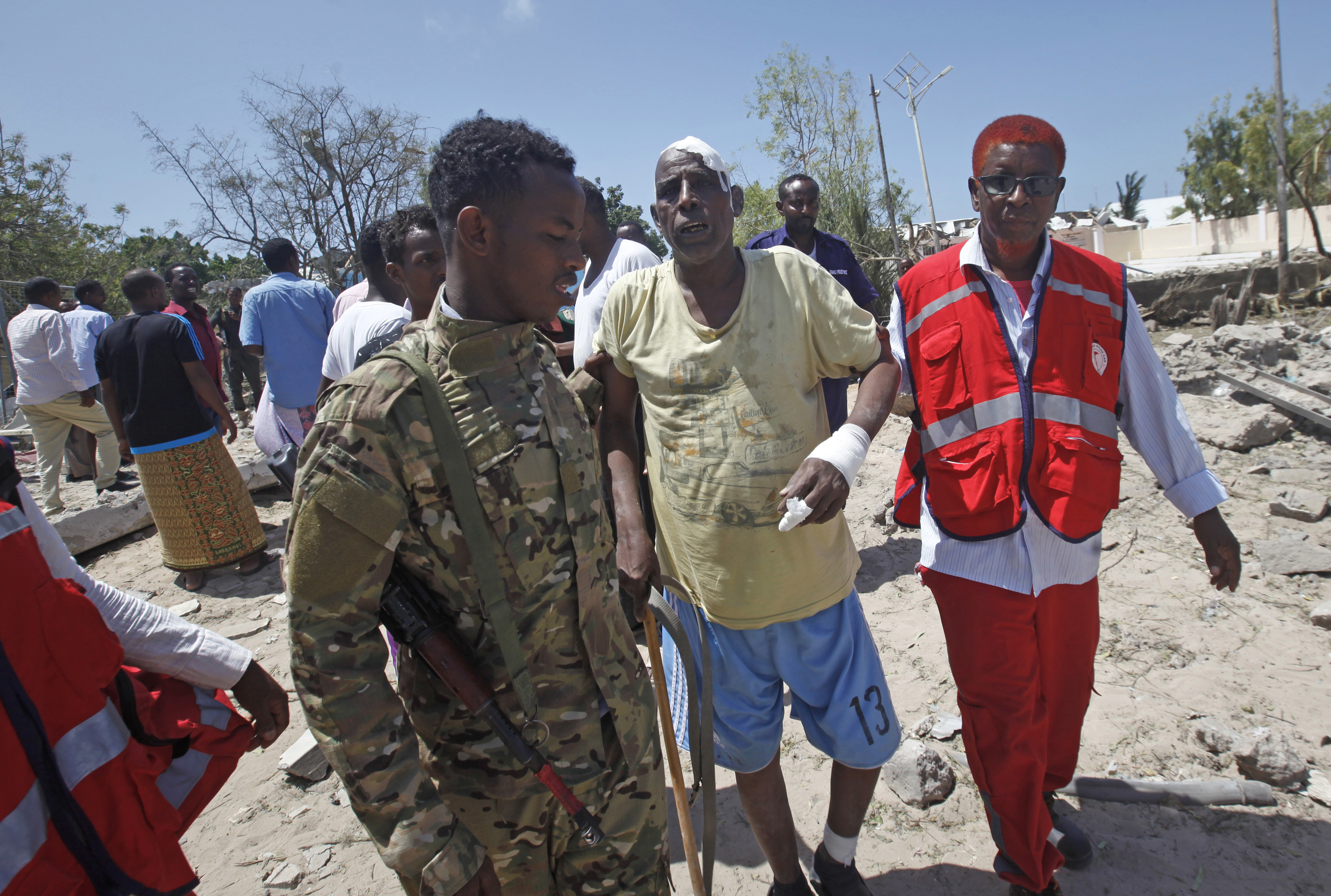 A Somali soldier and medic help a civilian who was wounded in a blast in Mogadishu