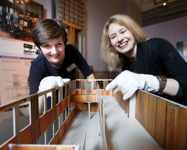 Museum curators with a scale model of Charles Rennie Mackintosh's Oak Room