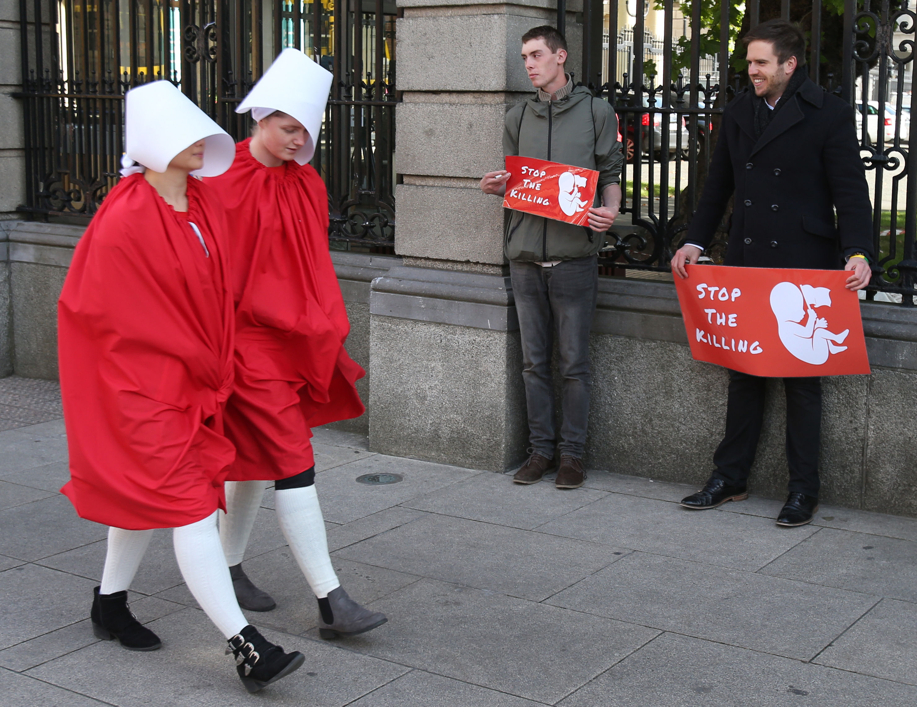 Two members of ROSA dressed as handmaids