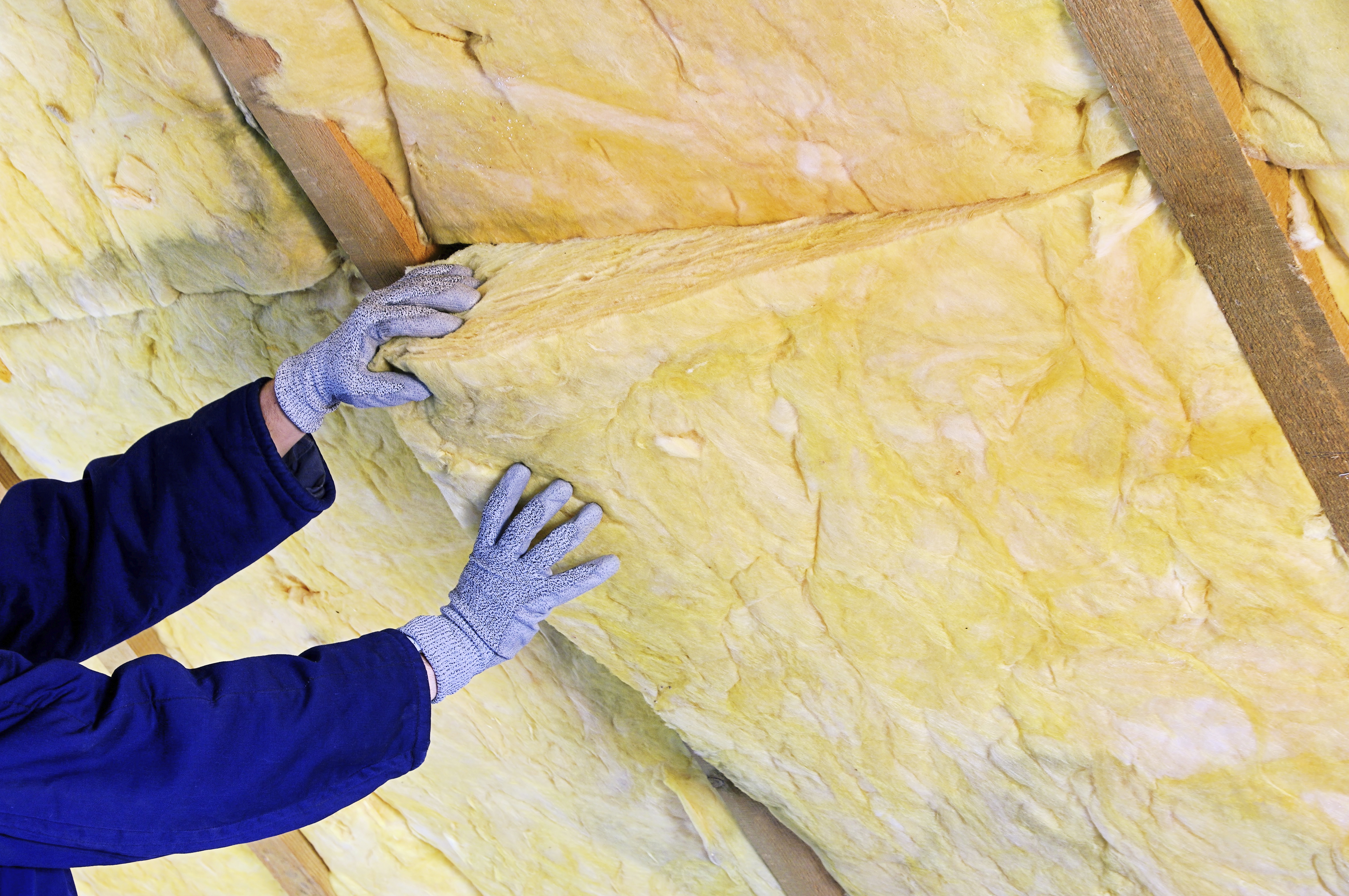 Two hands fitting insulating mineral rock wool (Thinkstock/EST/PA)