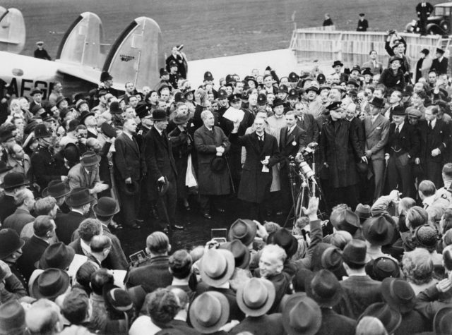 British Prime Minister Neville Chamberlain holds aloft the Anglo German Declaration to a cheering crowd in Britain, which features in the book The War on Paper (IWM/PA)