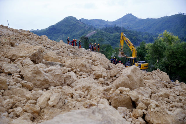 Rescuers dig through the rubble