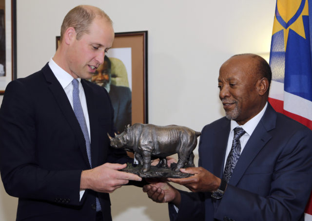 William is presented with a sculpture of a rhino by vice president Nangolo Mbumba