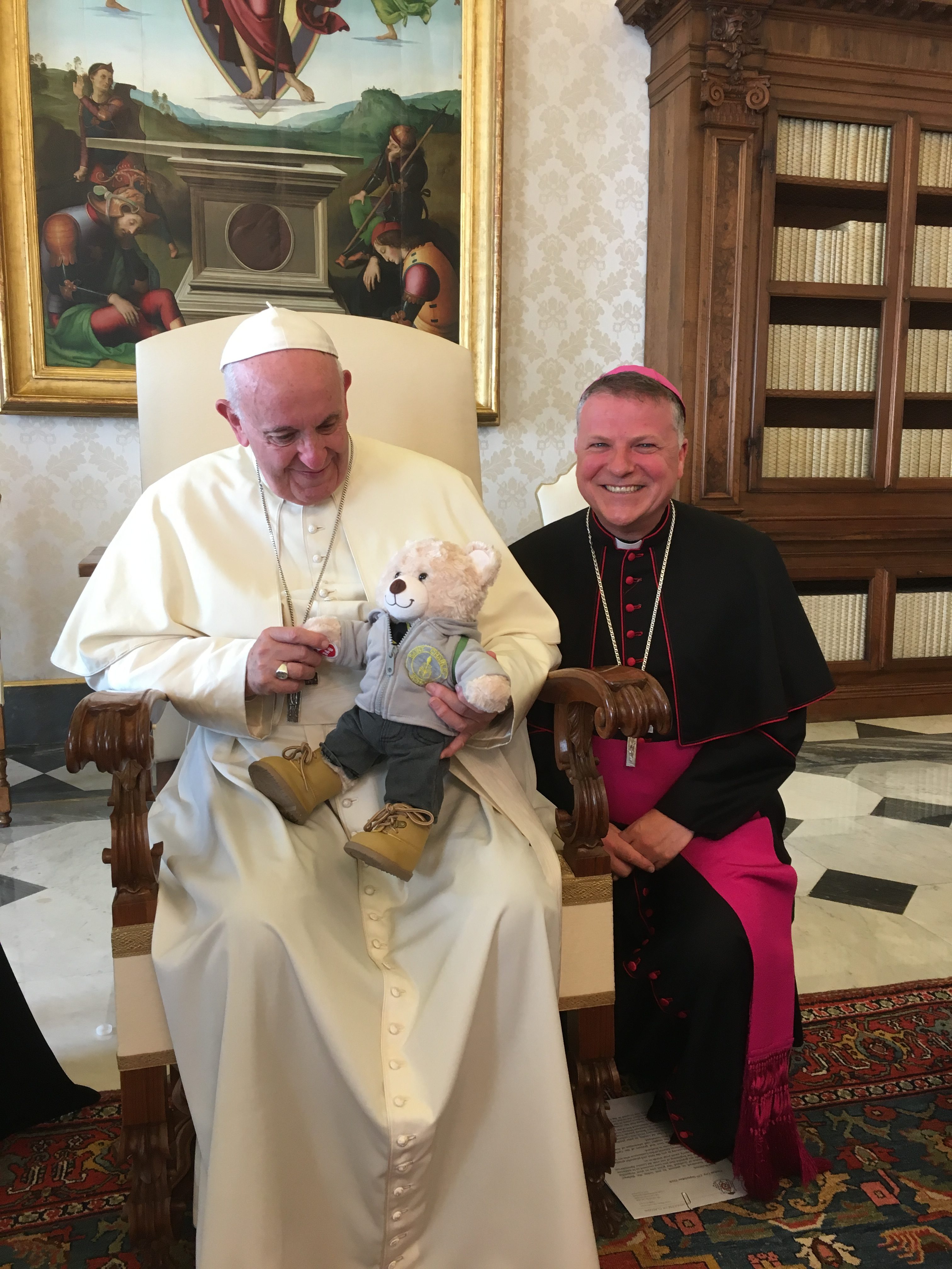 Pope Francis with a teddy bear and Bishop John Keenan