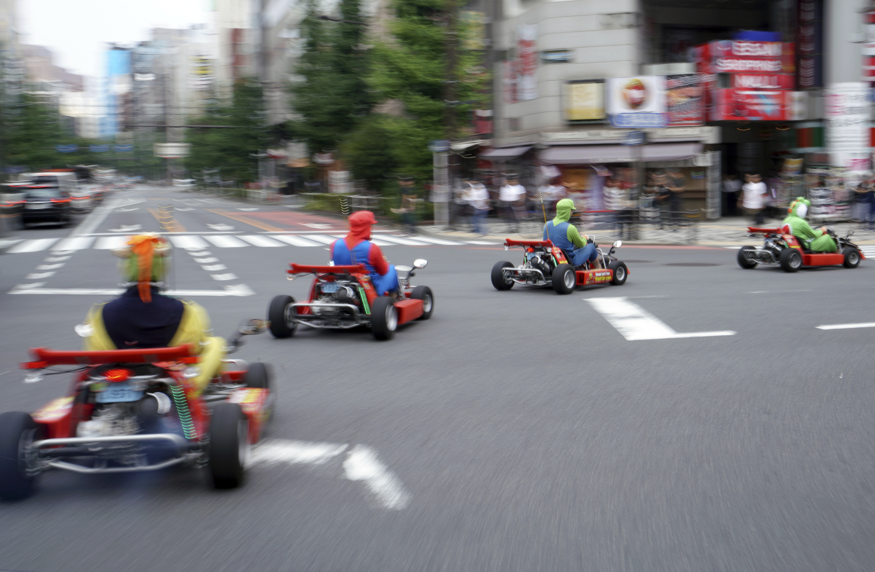 Tourists drive carts on a street in the Akihabara shopping and tourist district of Tokyo 