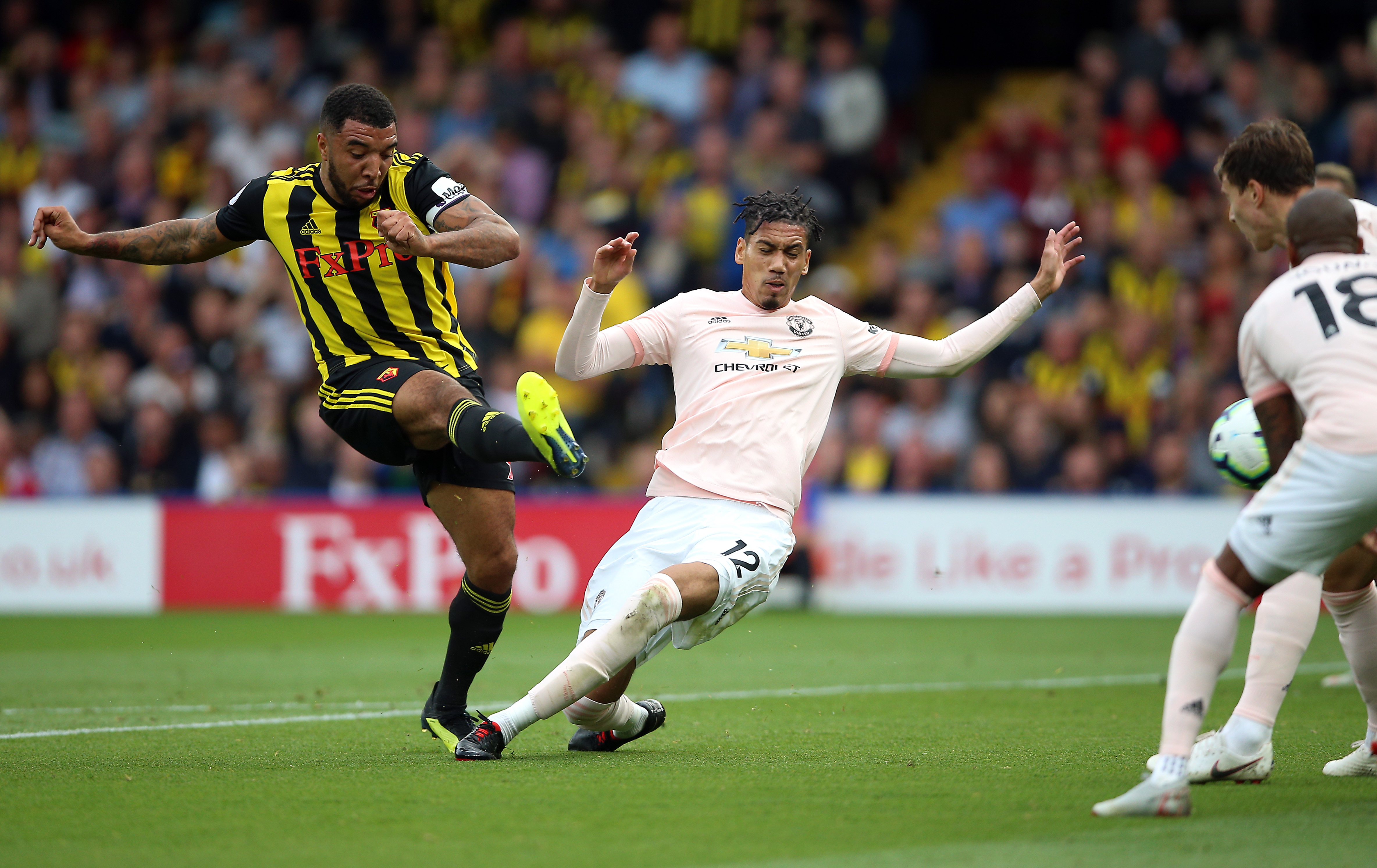 Watford's Troy Deeney (left) shoots towards goal during the Premier League match at Vicarage Road, Watford 