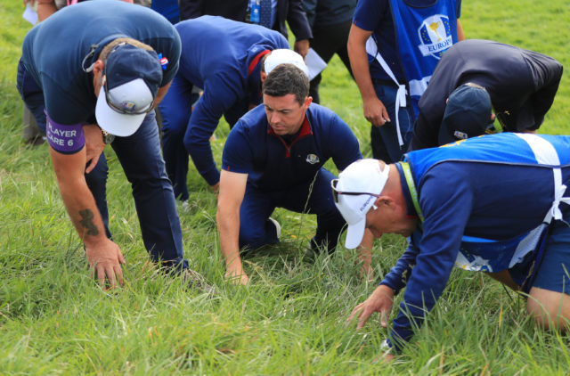 Rory McIlroy searches for his ball
