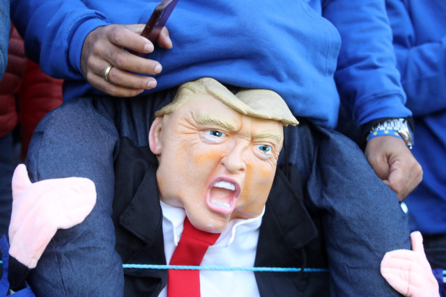 A fan with a Donald Trump doll