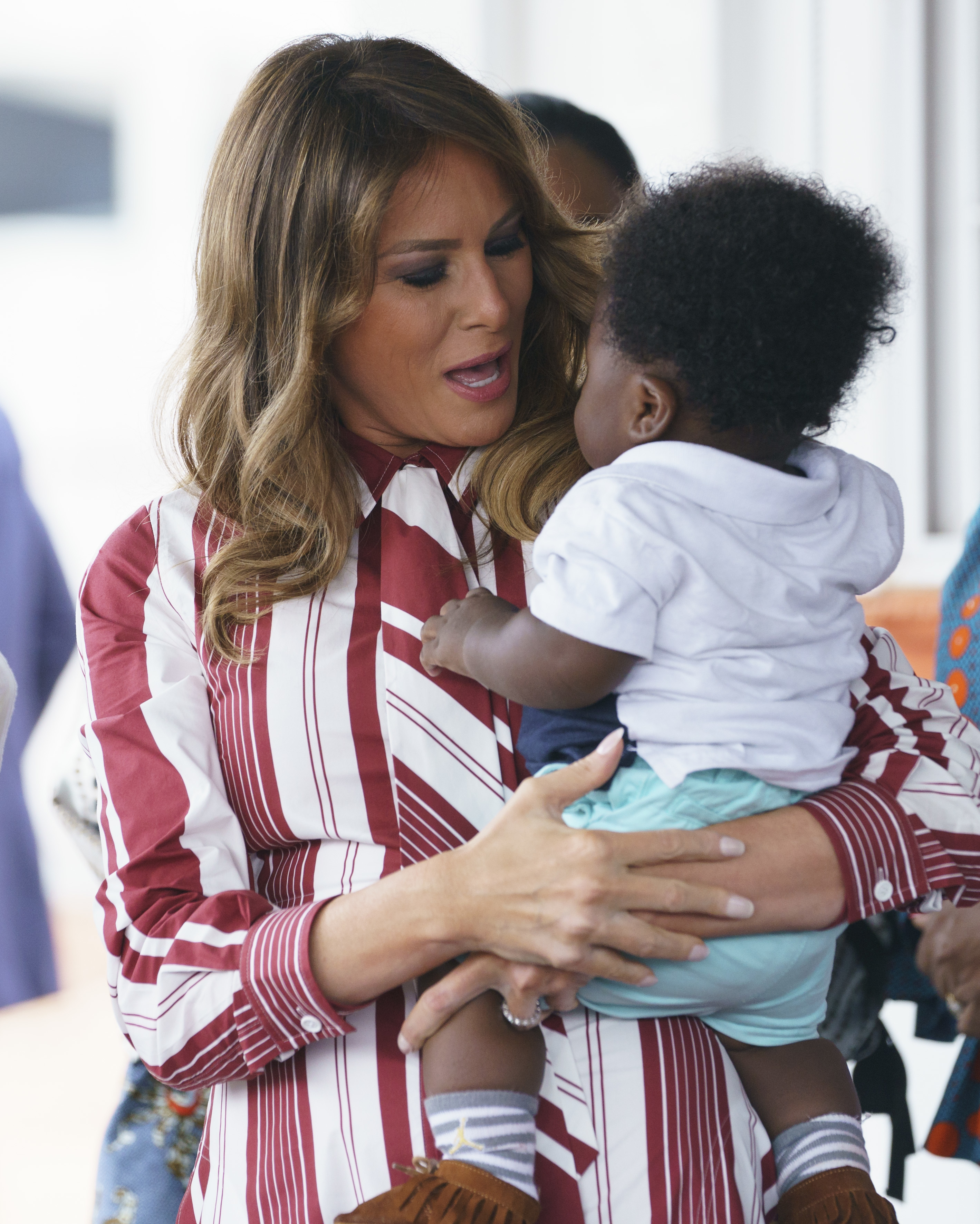 Melania Trump holds a baby at Greater Accra Regional Hospital