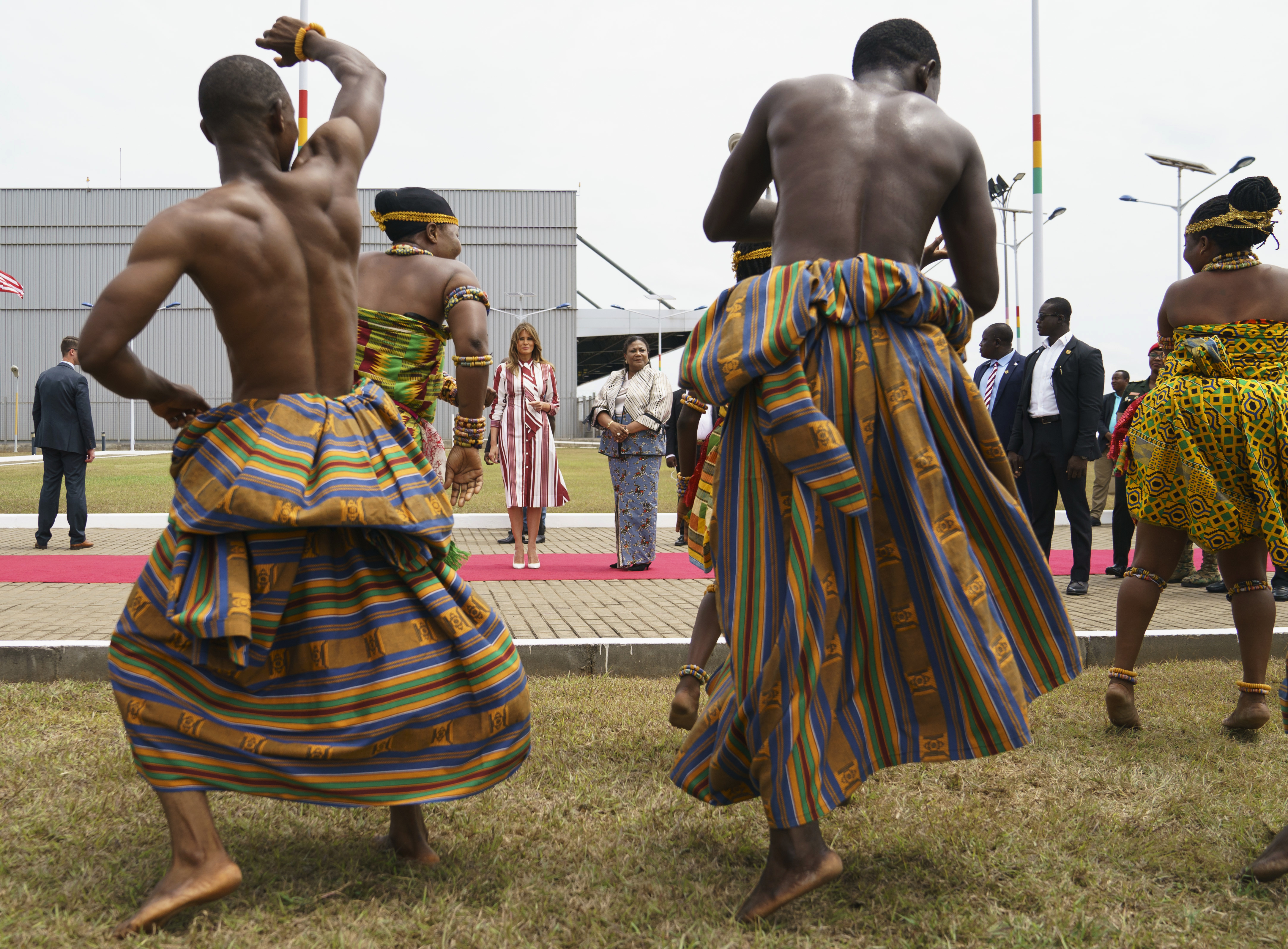 Melania Trump and Rebecca Akufo-Addo watch dancers during an arrival ceremony at Kotoka International Airport in Accra