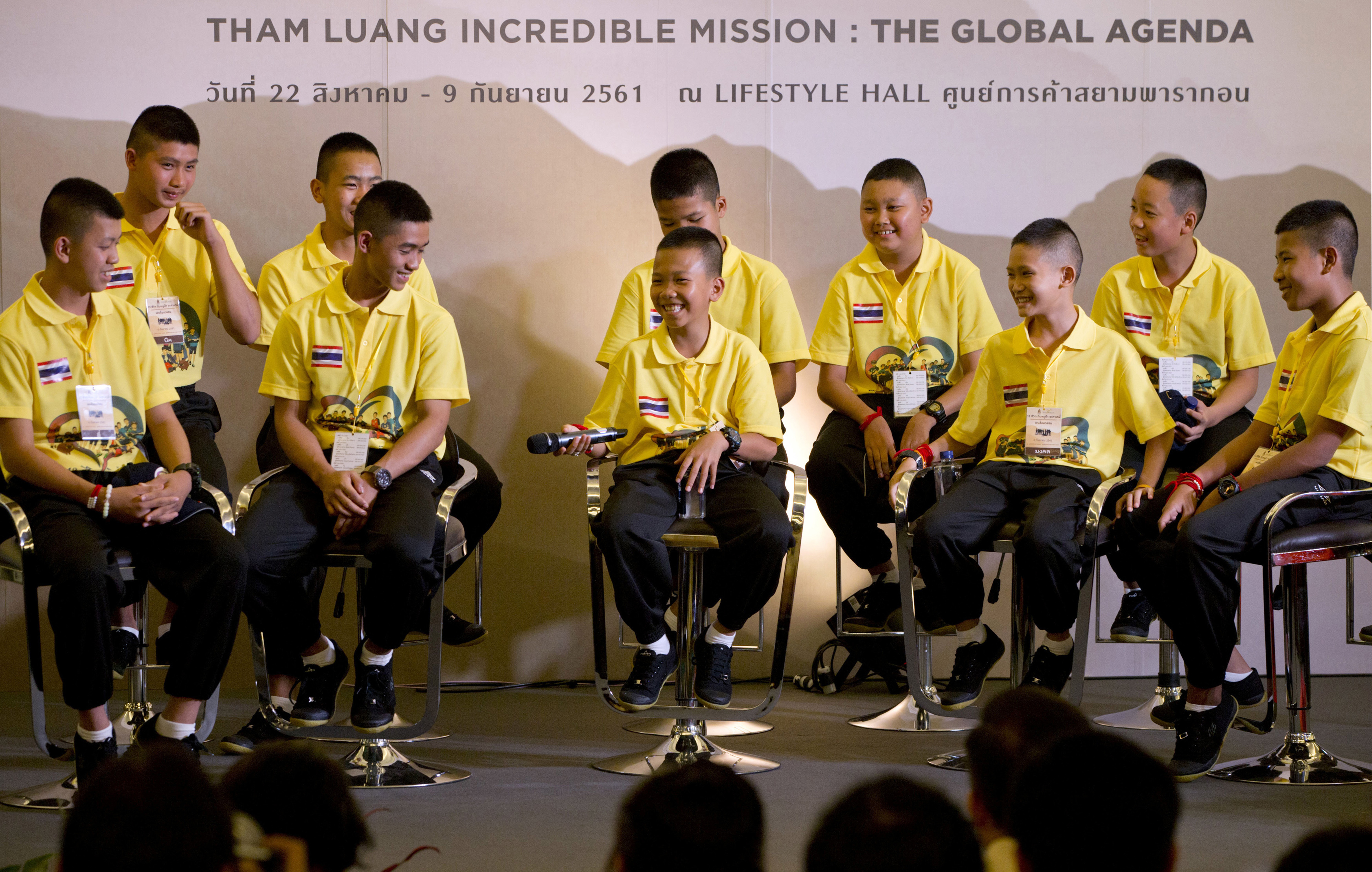 Members of the Wild Boars team laugh during a media conference